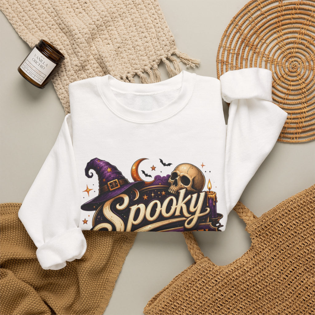 White crewneck sweatshirt styled flat with a candle — neon Spooky Witch Motel sign