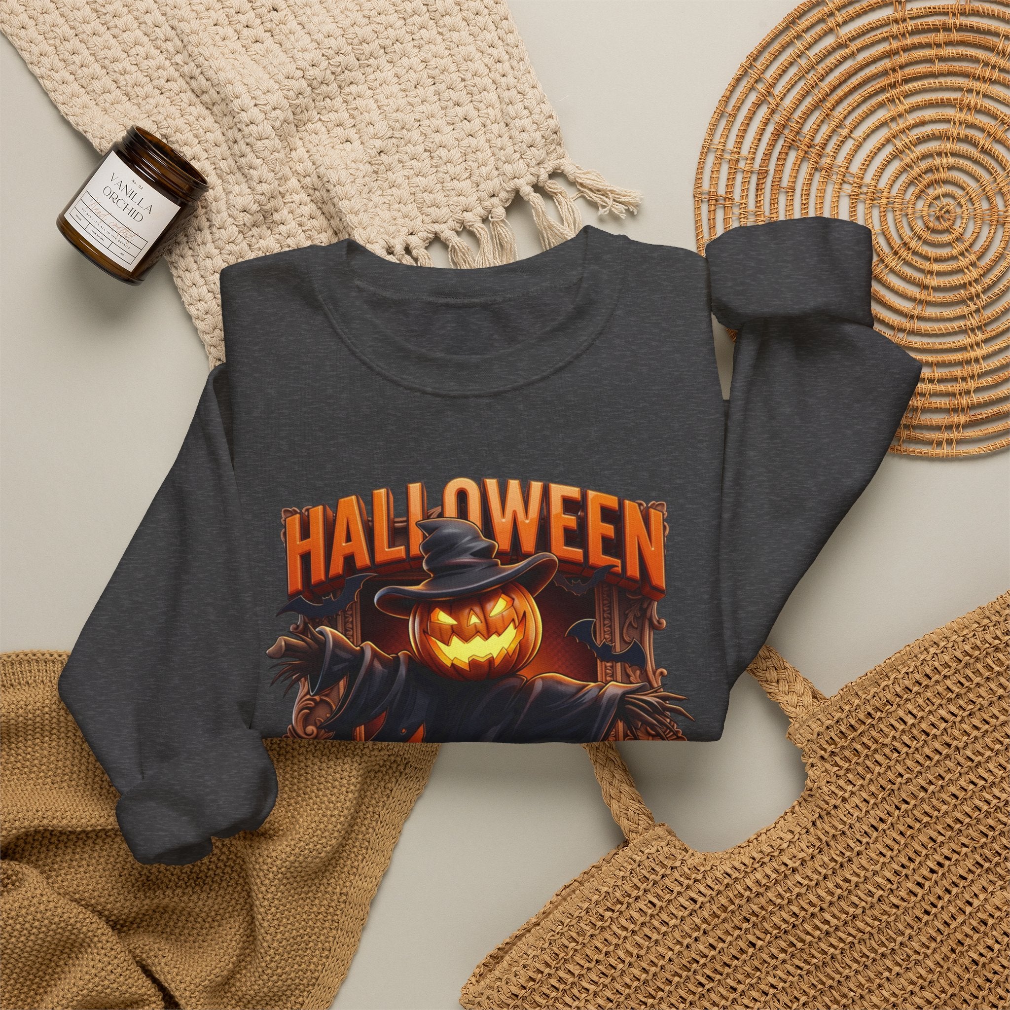 Dark Heather crewneck sweatshirt styled flat with a candle — scarecrow with a jack-o-lantern head