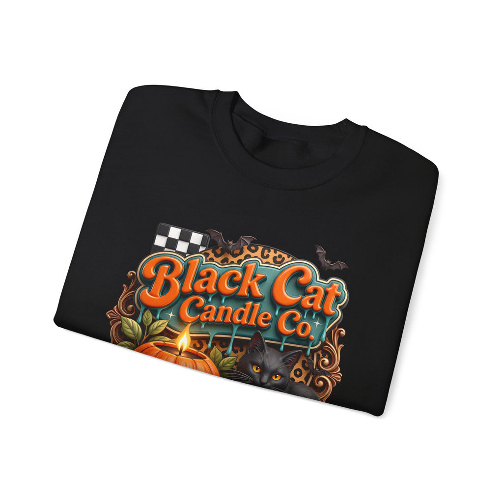 Black crewneck sweatshirt folded to show the retro teal signboard reads black cat candle co print