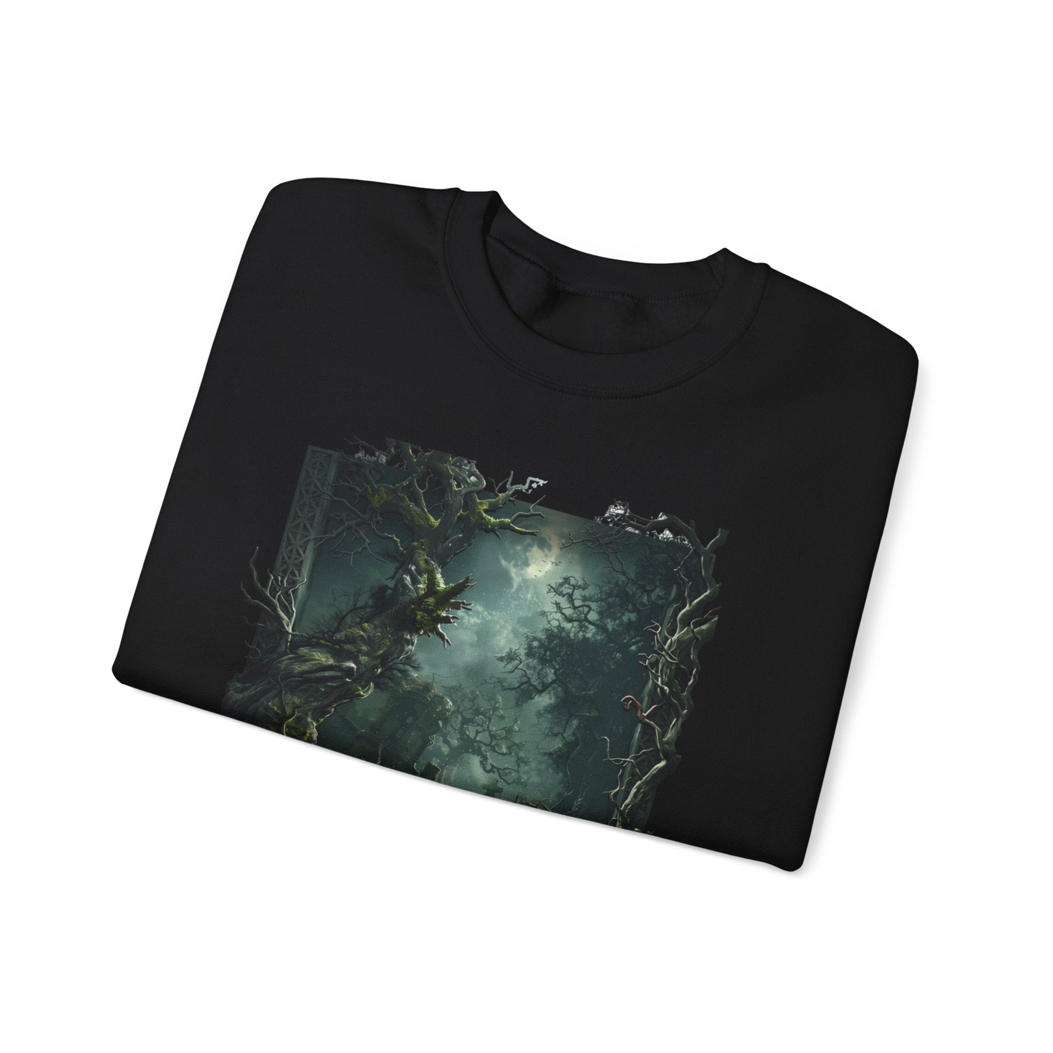 Black crewneck sweatshirt folded to show the moonlit forest of gnarled mossy trees drifts into pale print