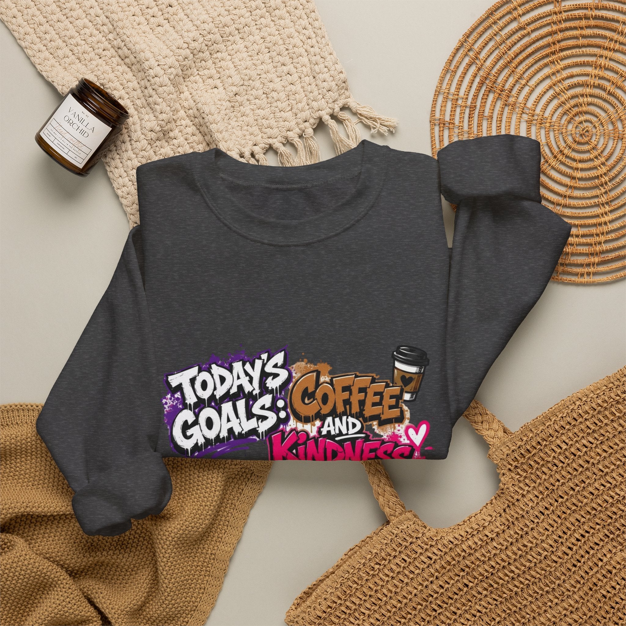 Dark Heather crewneck sweatshirt styled flat with a candle — graffiti lettering in electric pinks