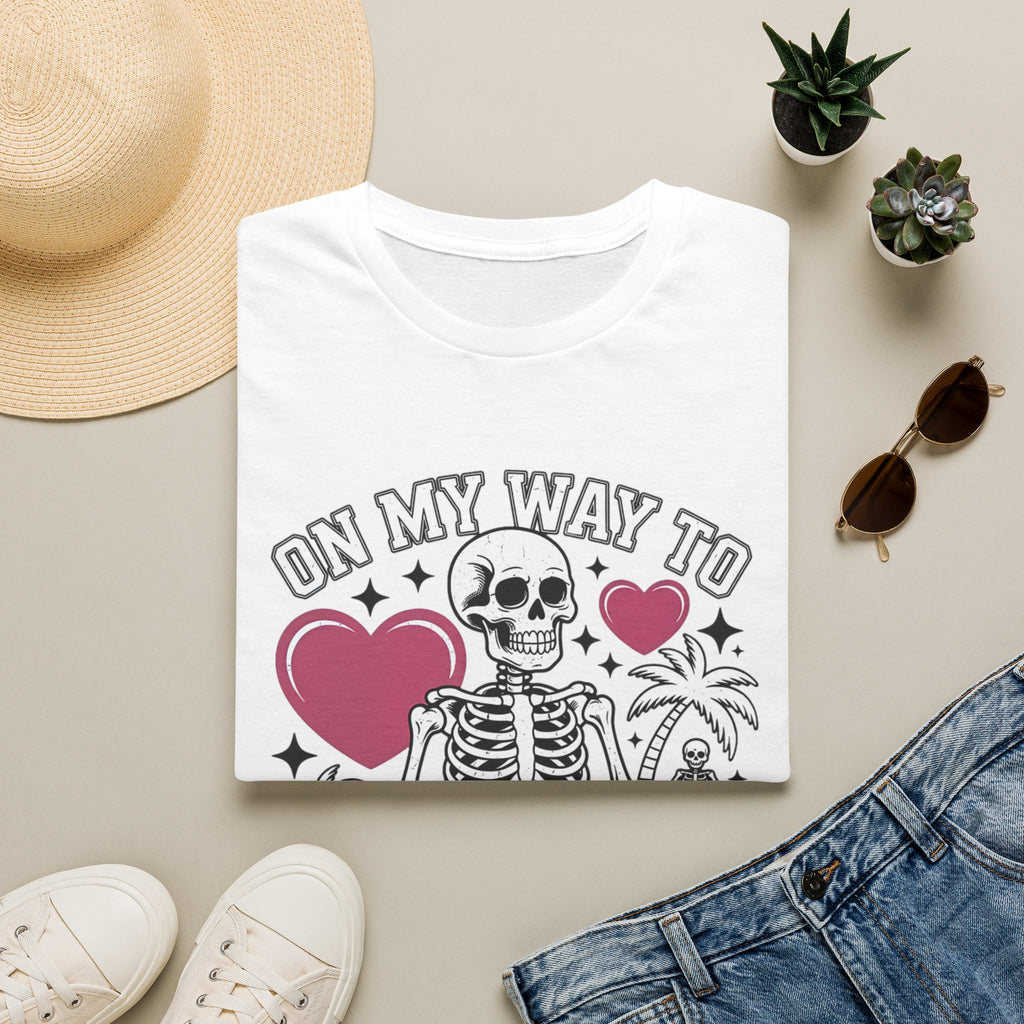 White t-shirt styled flat with a candle — line-drawn skeletons under pink hearts