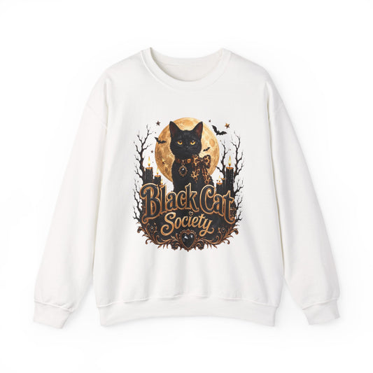 White crewneck sweatshirt laid flat, printed with a black cat sits before a glowing full moon