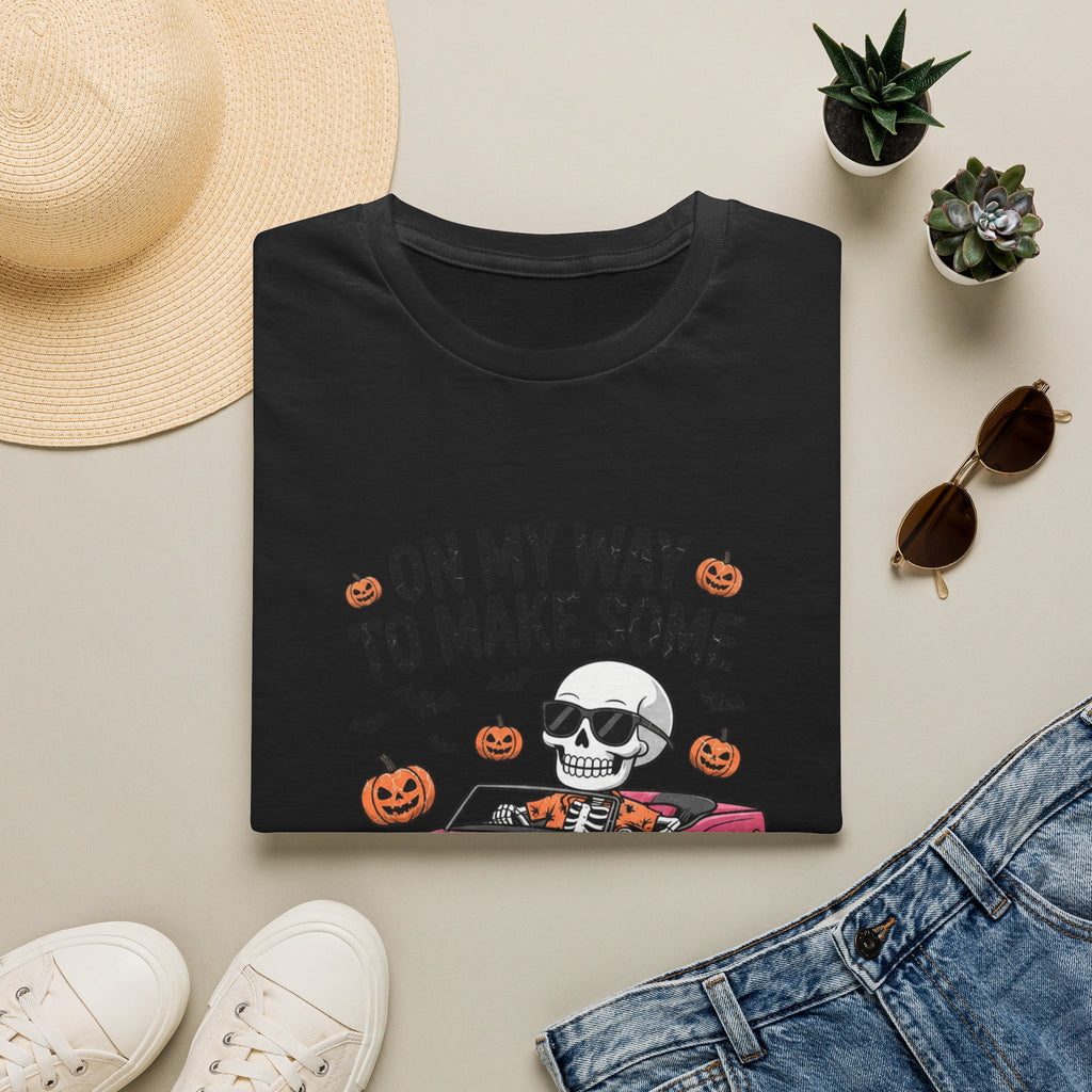 Black t-shirt styled flat with a candle — pink convertible car and a skull