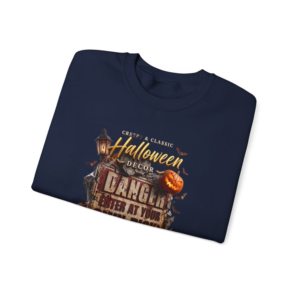 Navy crewneck sweatshirt folded to show the aged danger sign hangs above a cluster of glowing print