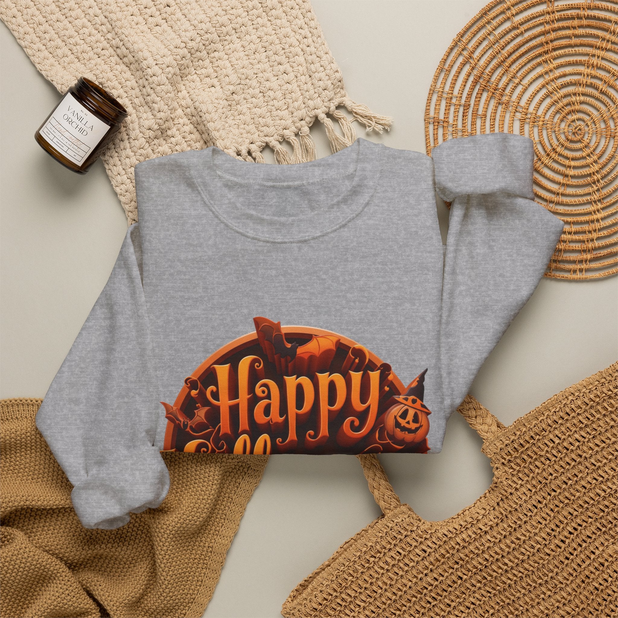 Sport Grey crewneck sweatshirt styled flat with a candle — glowing orange Happy Halloween badge