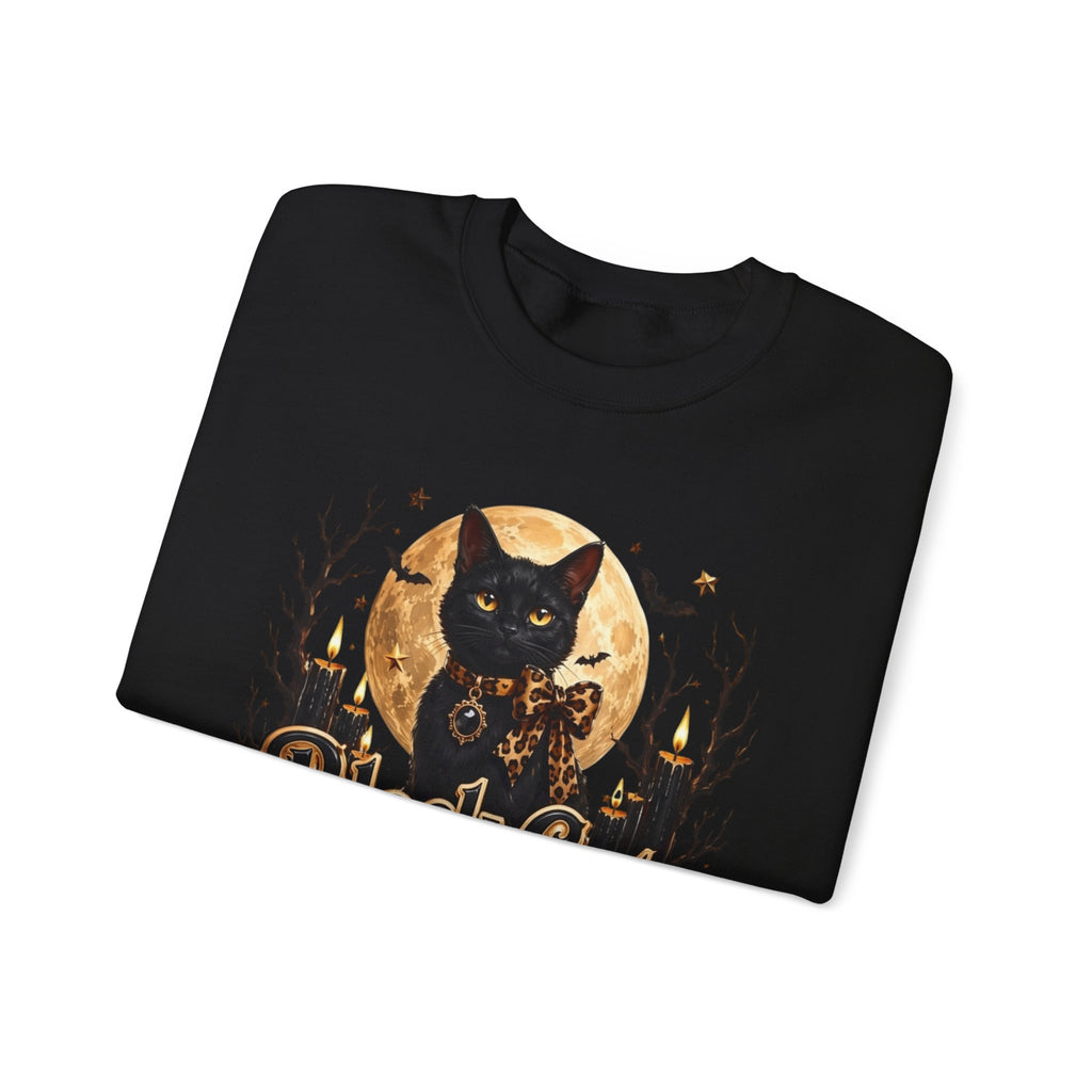 Black crewneck sweatshirt folded to show the black cat sits before a glowing full moon print