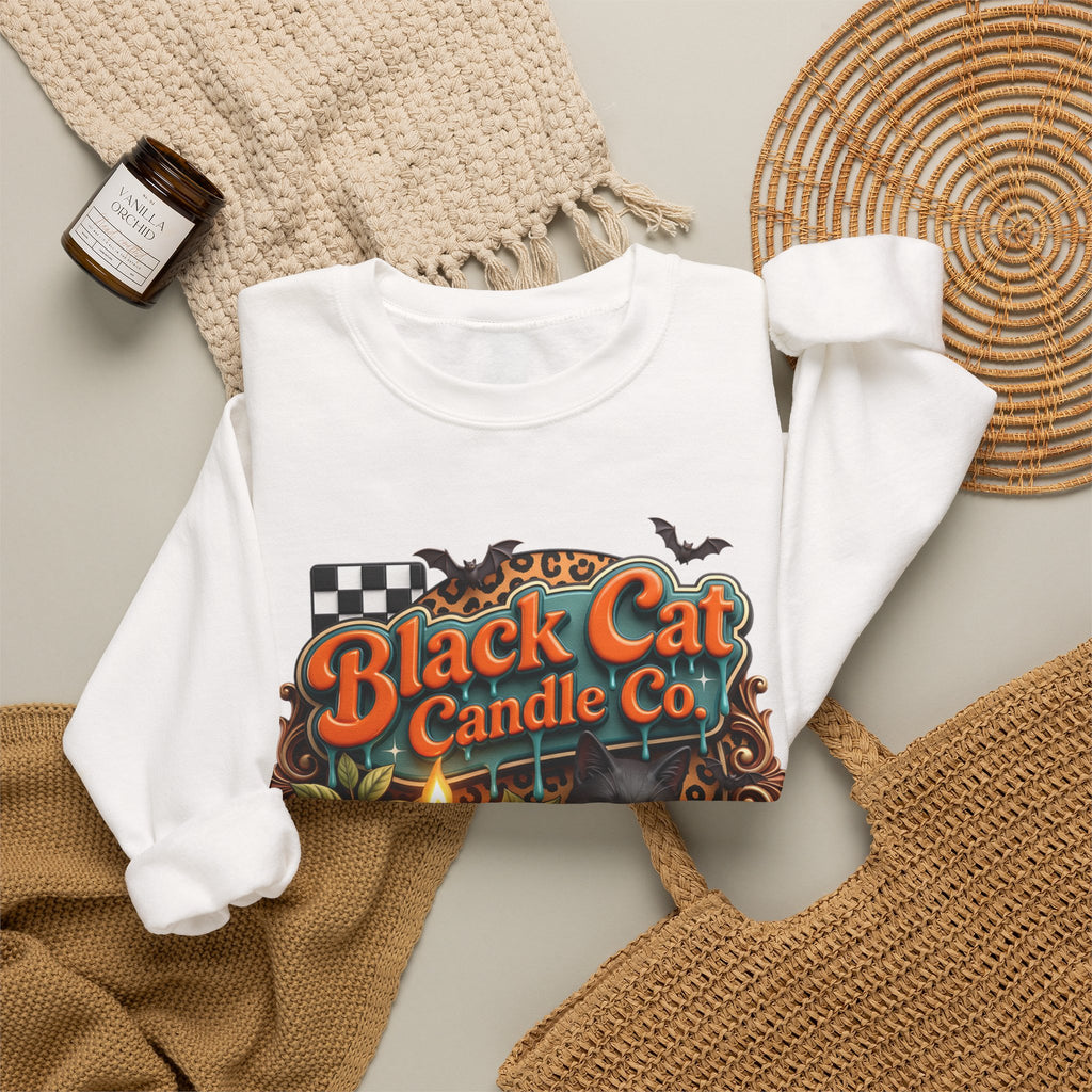 White crewneck sweatshirt styled flat with a candle — retro Black Cat Candle Co signboard