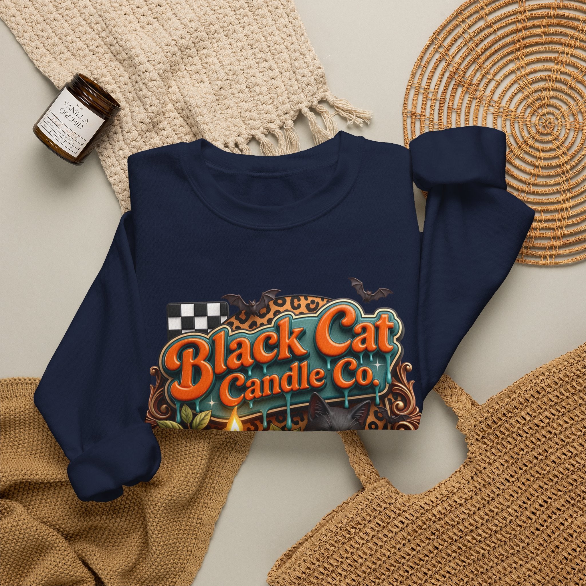 Navy crewneck sweatshirt styled flat with a candle — retro Black Cat Candle Co signboard