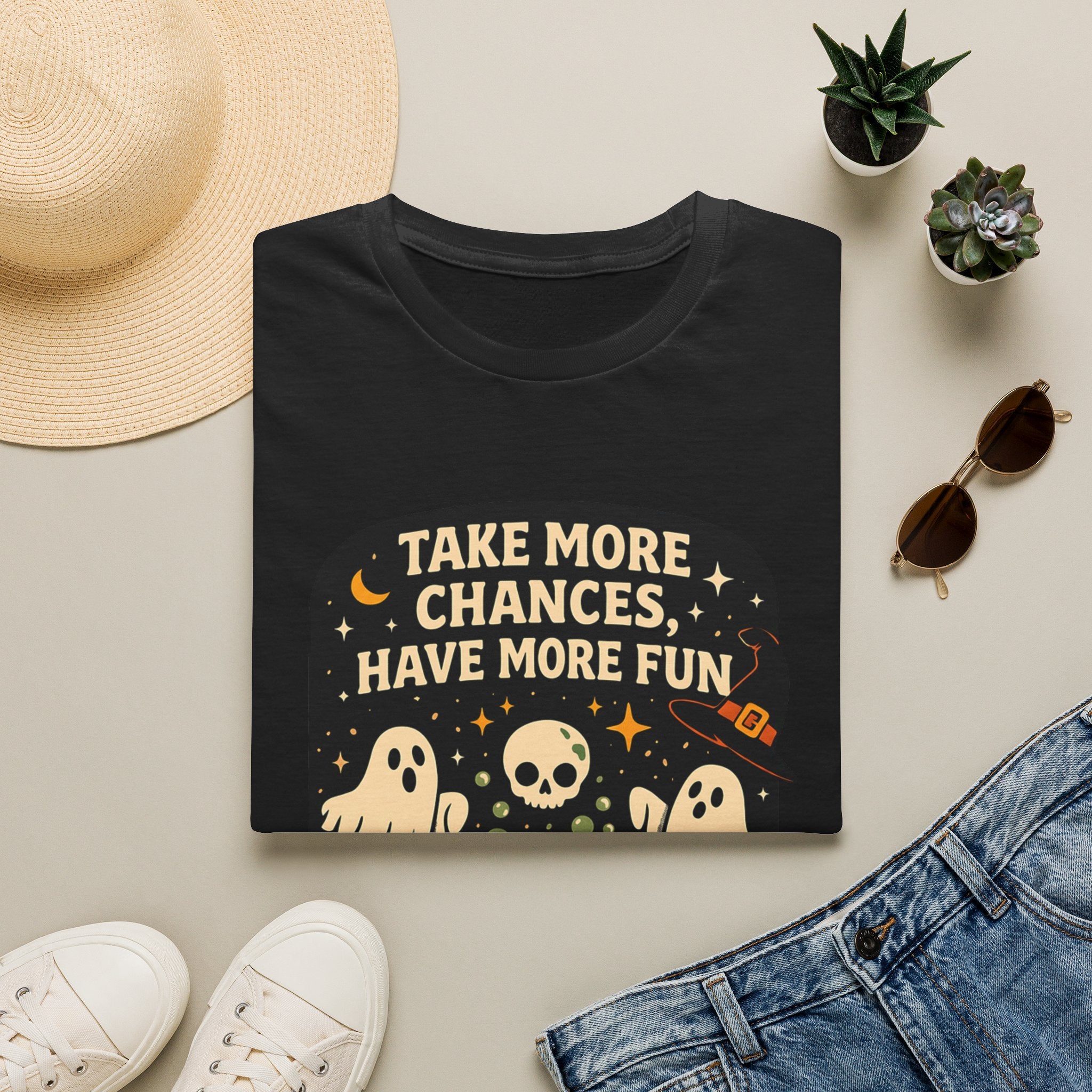 Black t-shirt styled flat with a candle — two ghosts around a campfire
