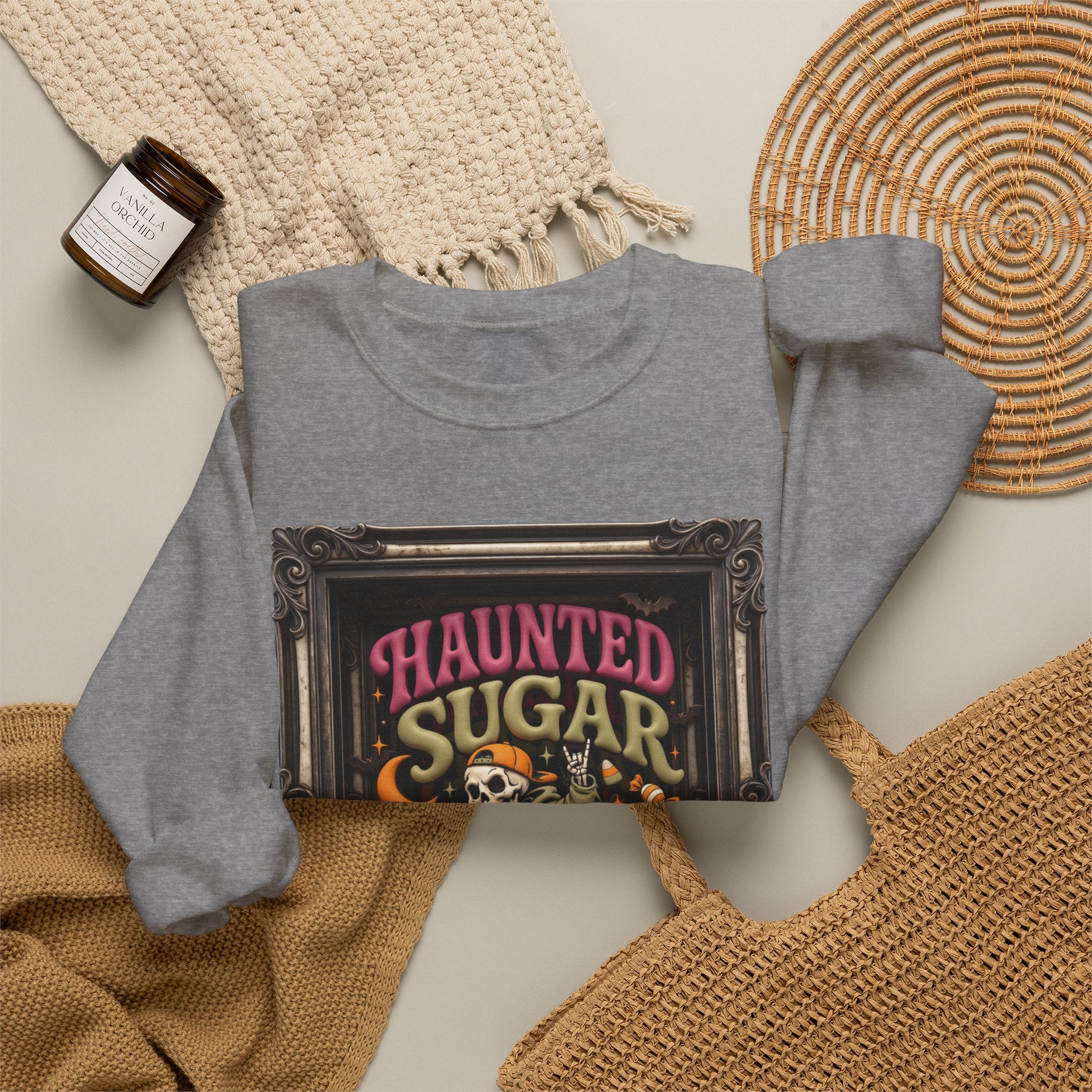 Graphite Heather crewneck sweatshirt styled flat with a candle — hooded skeleton riding a broom