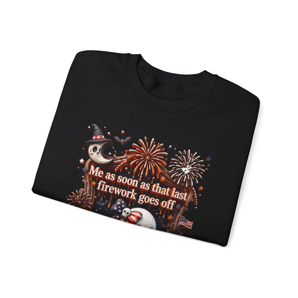 Black crewneck sweatshirt folded to show the wide-eyed ghost clutches a striped firework print