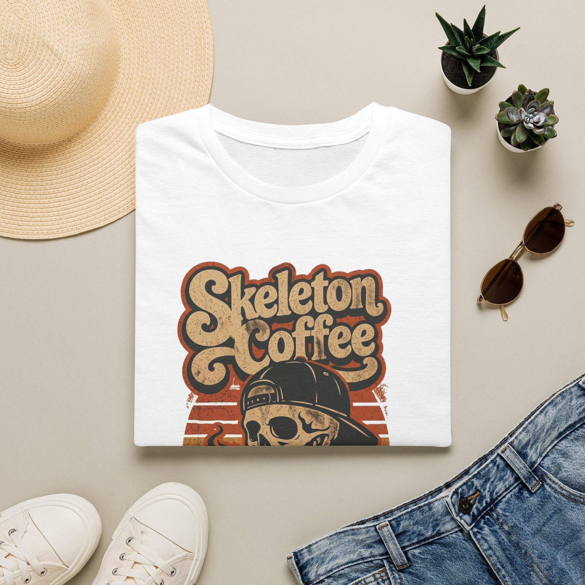 White t-shirt styled flat with a candle — skeleton in a sweater holding coffee