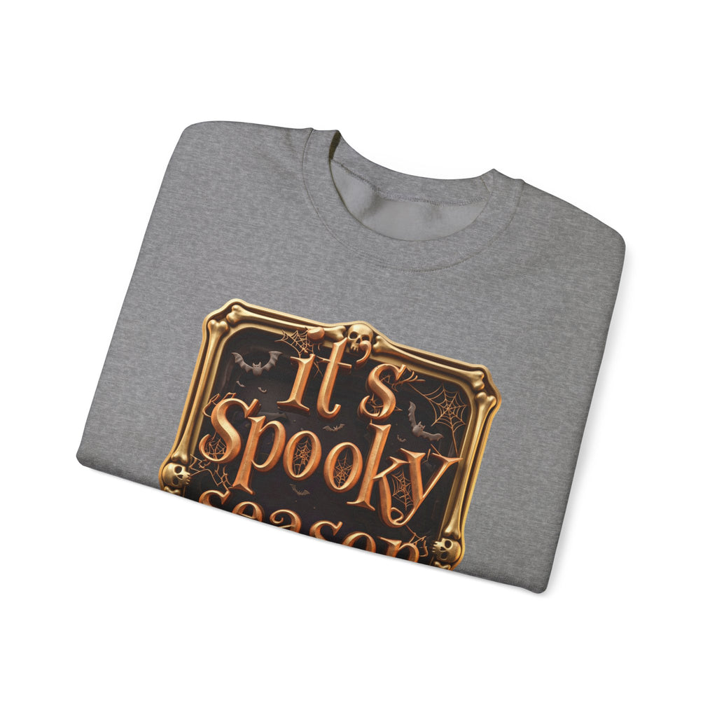 Graphite Heather crewneck sweatshirt folded to show the copper serif lettering reads it's spooky season inside print