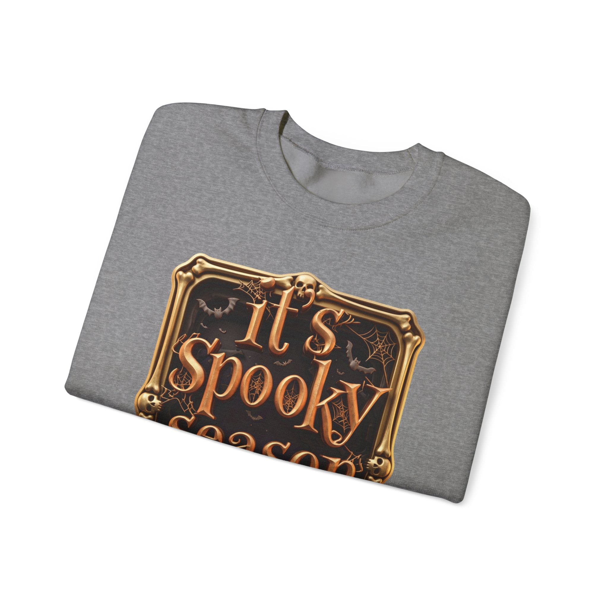 Graphite Heather crewneck sweatshirt folded to show the copper serif lettering reads it's spooky season inside print