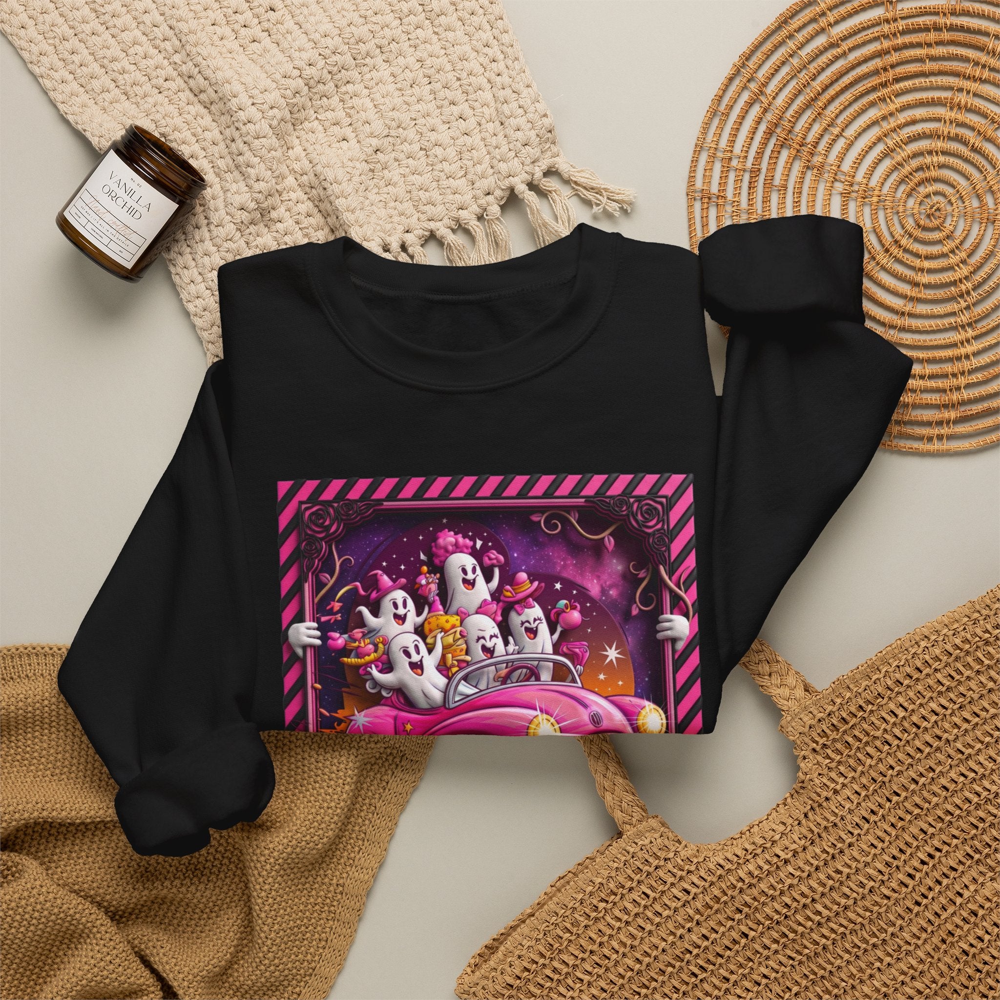 Black crewneck sweatshirt styled flat with a candle — ghosts in a pink convertible