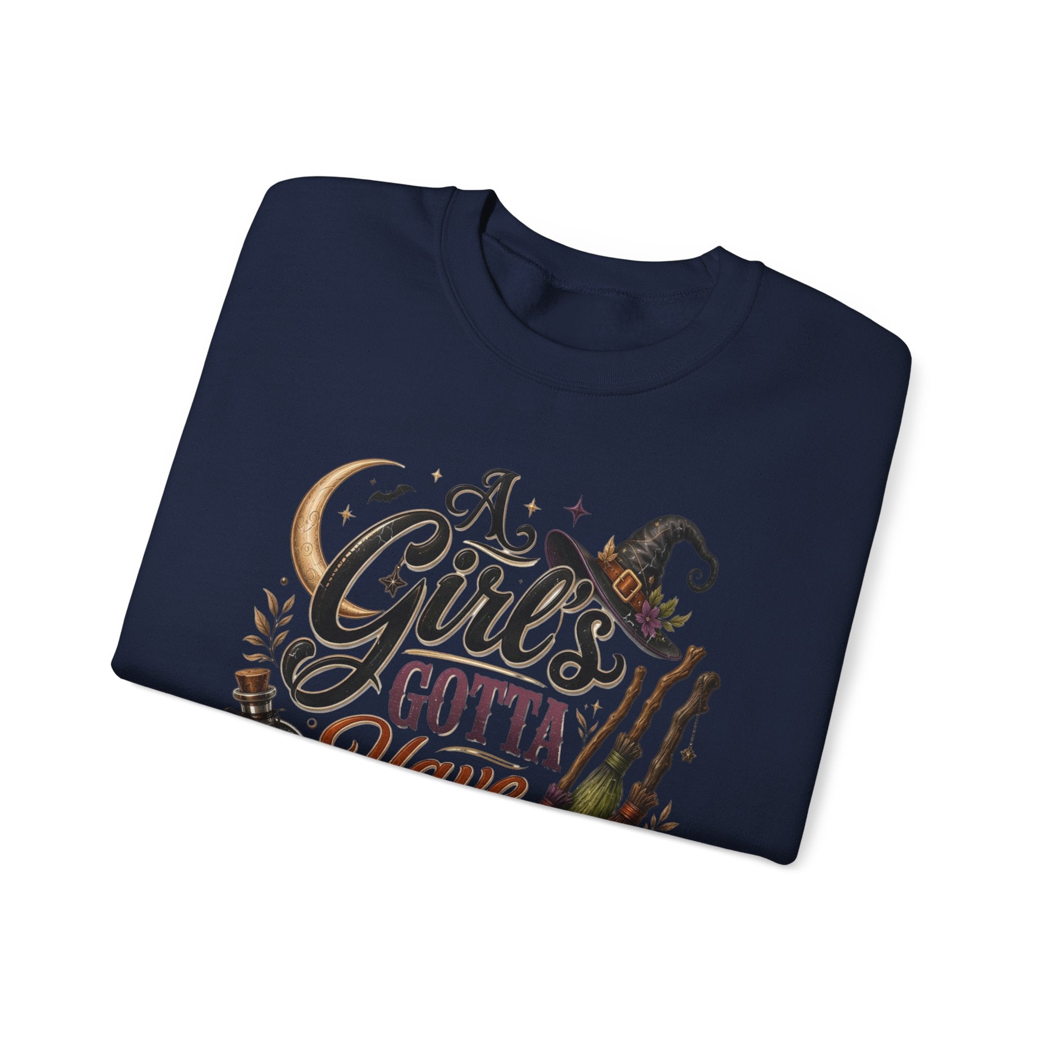 Navy crewneck sweatshirt folded to show the hand-lettered script reading a girl's gotta have options print