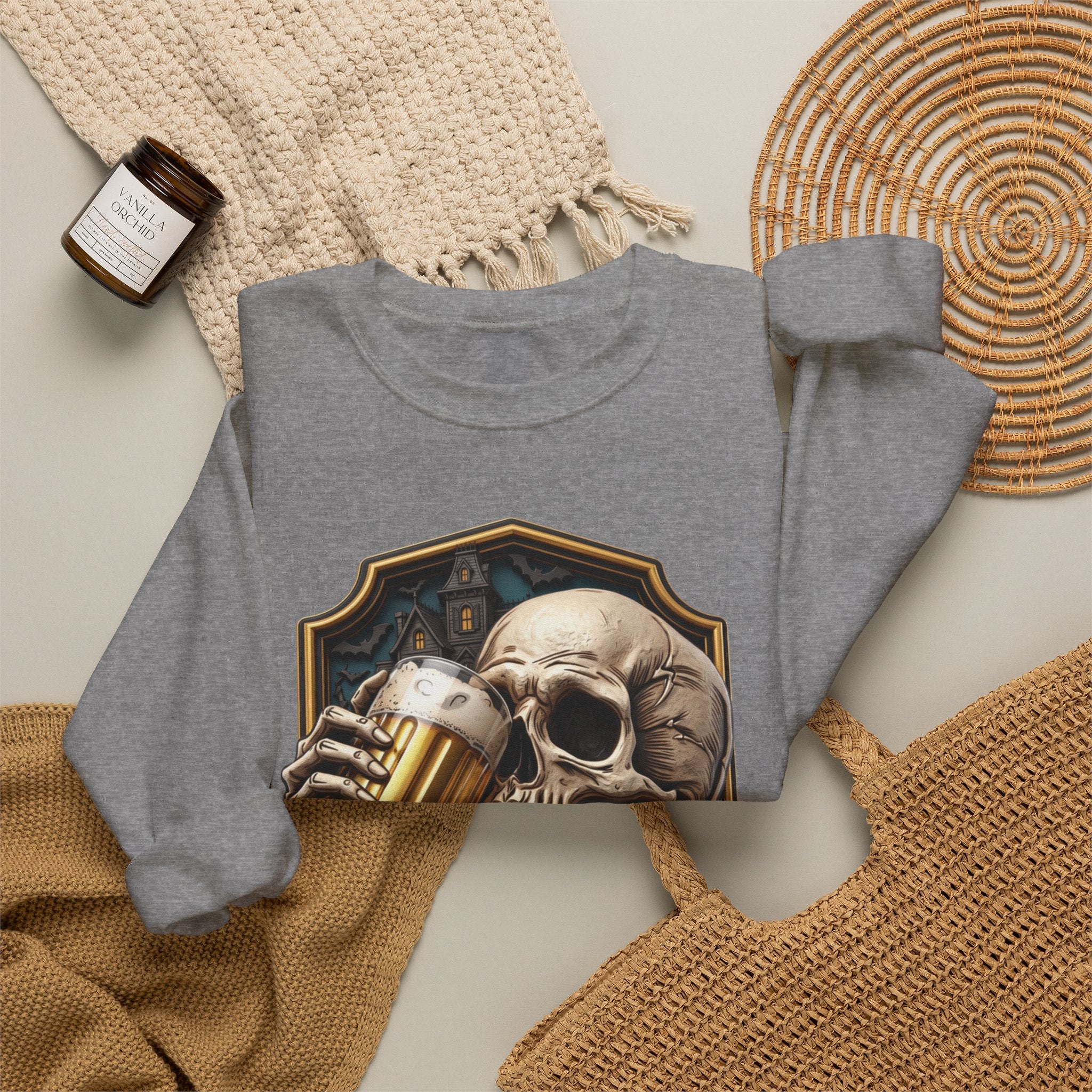 Graphite Heather crewneck sweatshirt styled flat with a candle — cracked skull with a beer mug