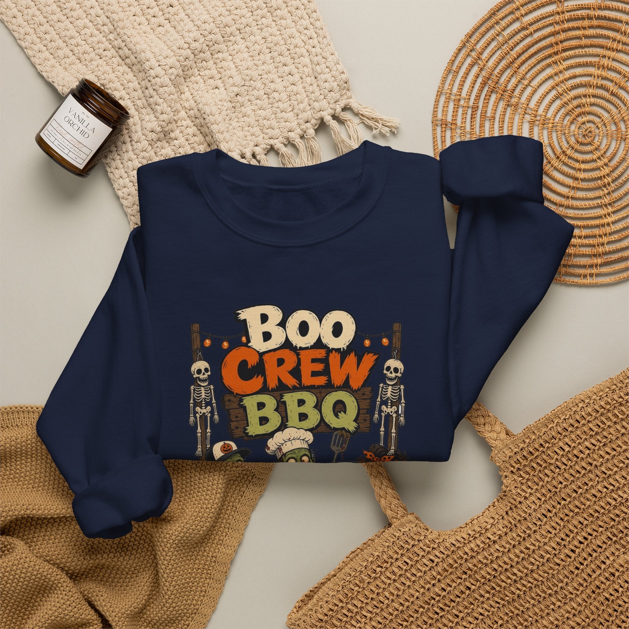 Navy crewneck sweatshirt styled flat with a candle — skeletons and zombies at the grill