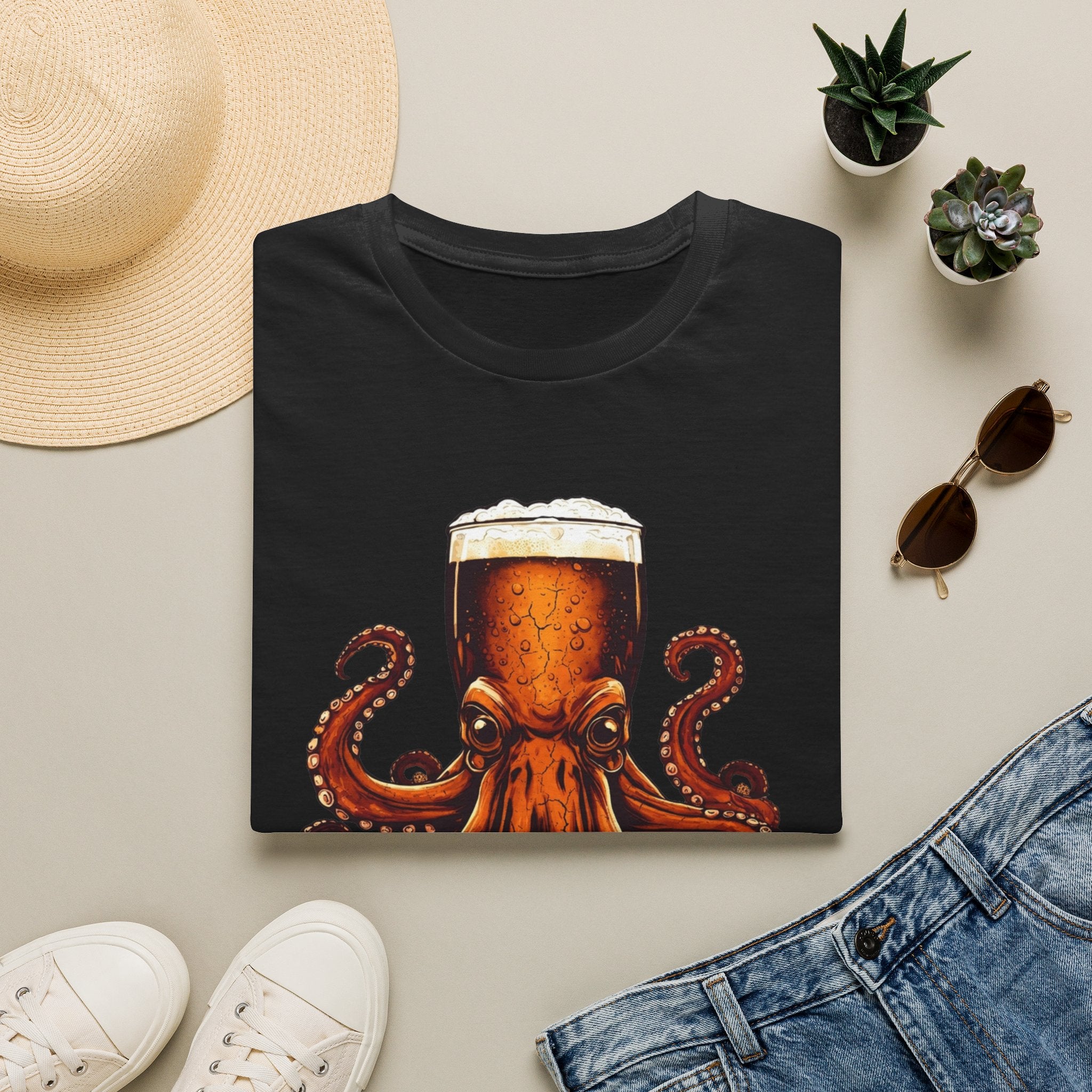 Black t-shirt styled flat with a candle — octopus wrapped around a beer glass