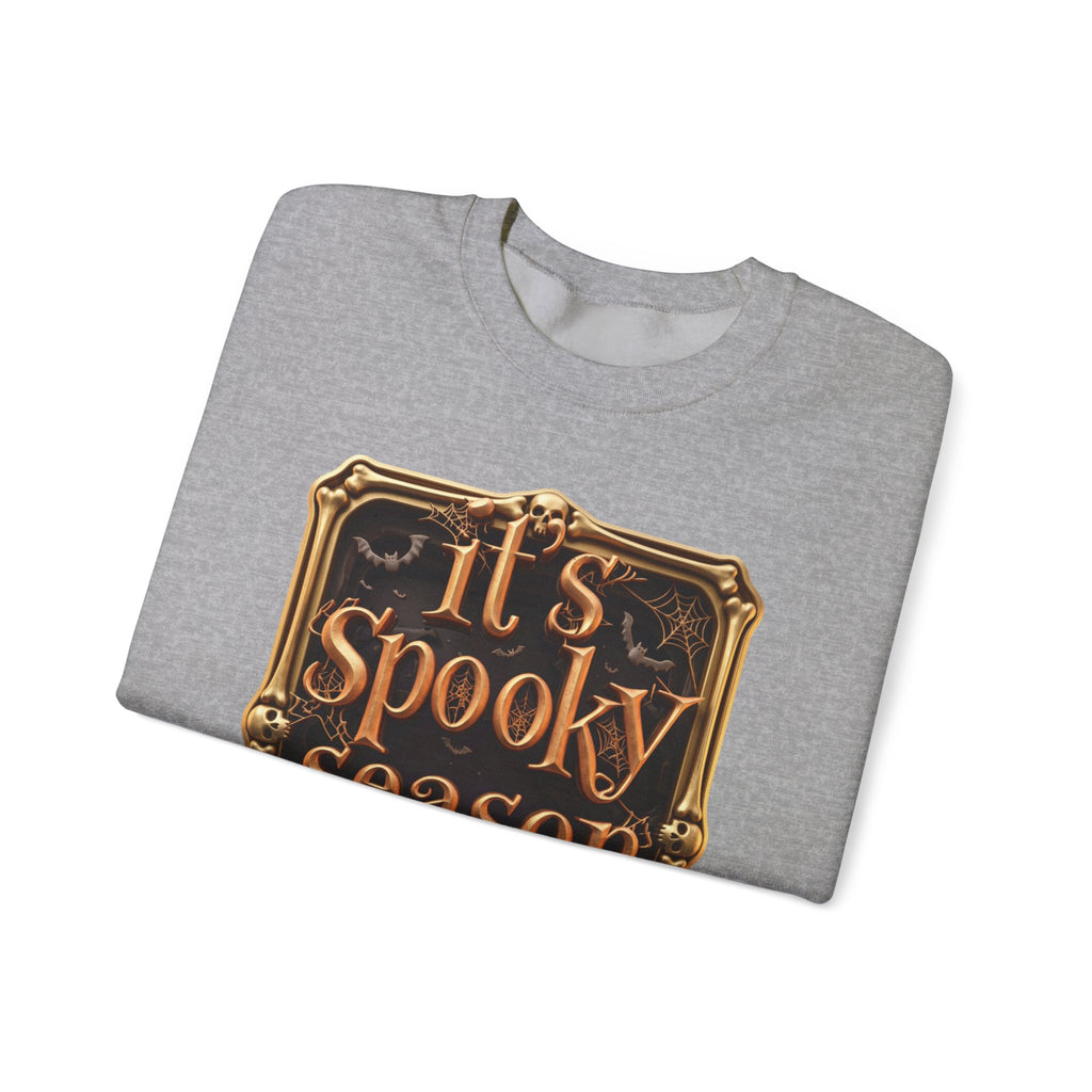 Sport Grey crewneck sweatshirt folded to show the copper serif lettering reads it's spooky season inside print