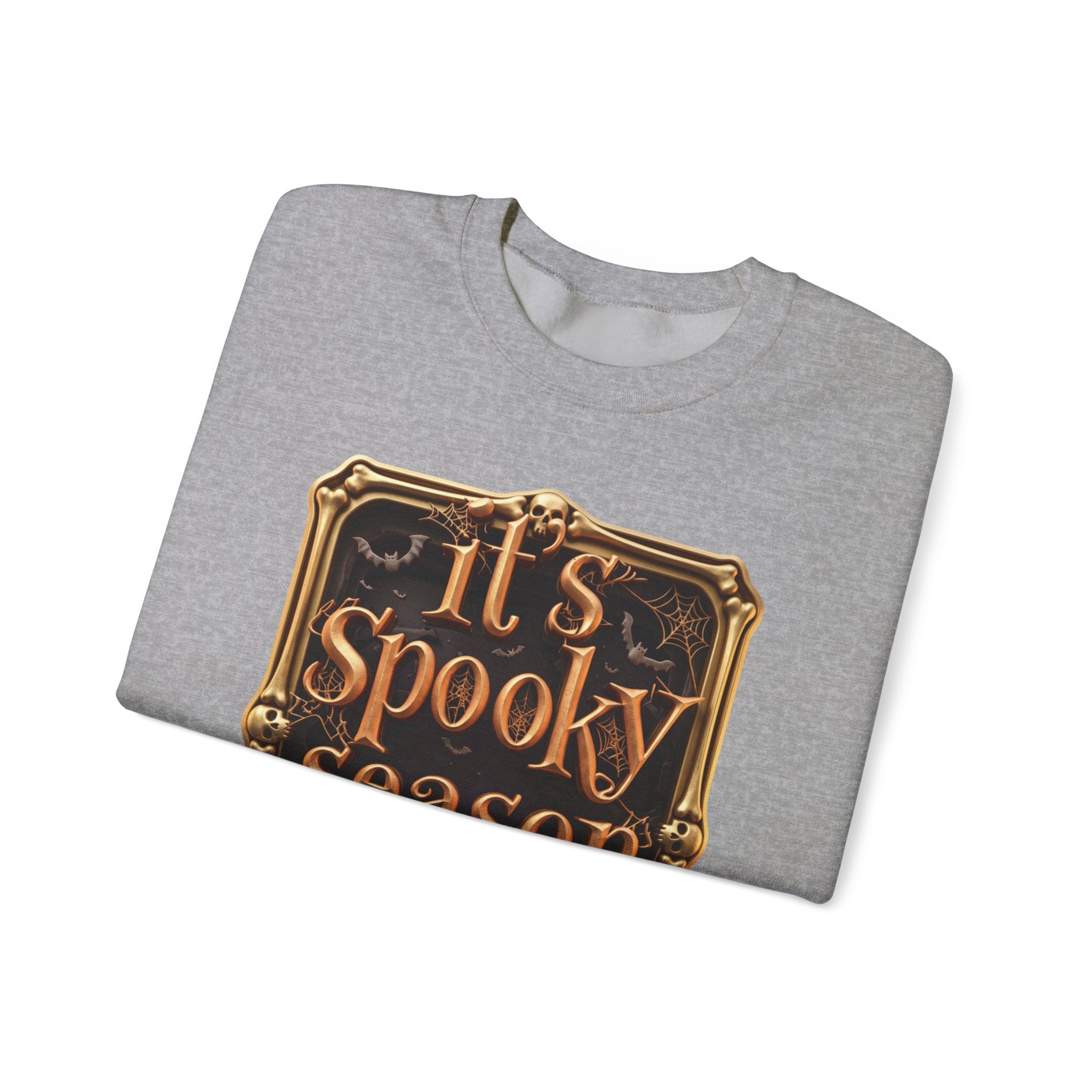 Sport Grey crewneck sweatshirt folded to show the copper serif lettering reads it's spooky season inside print