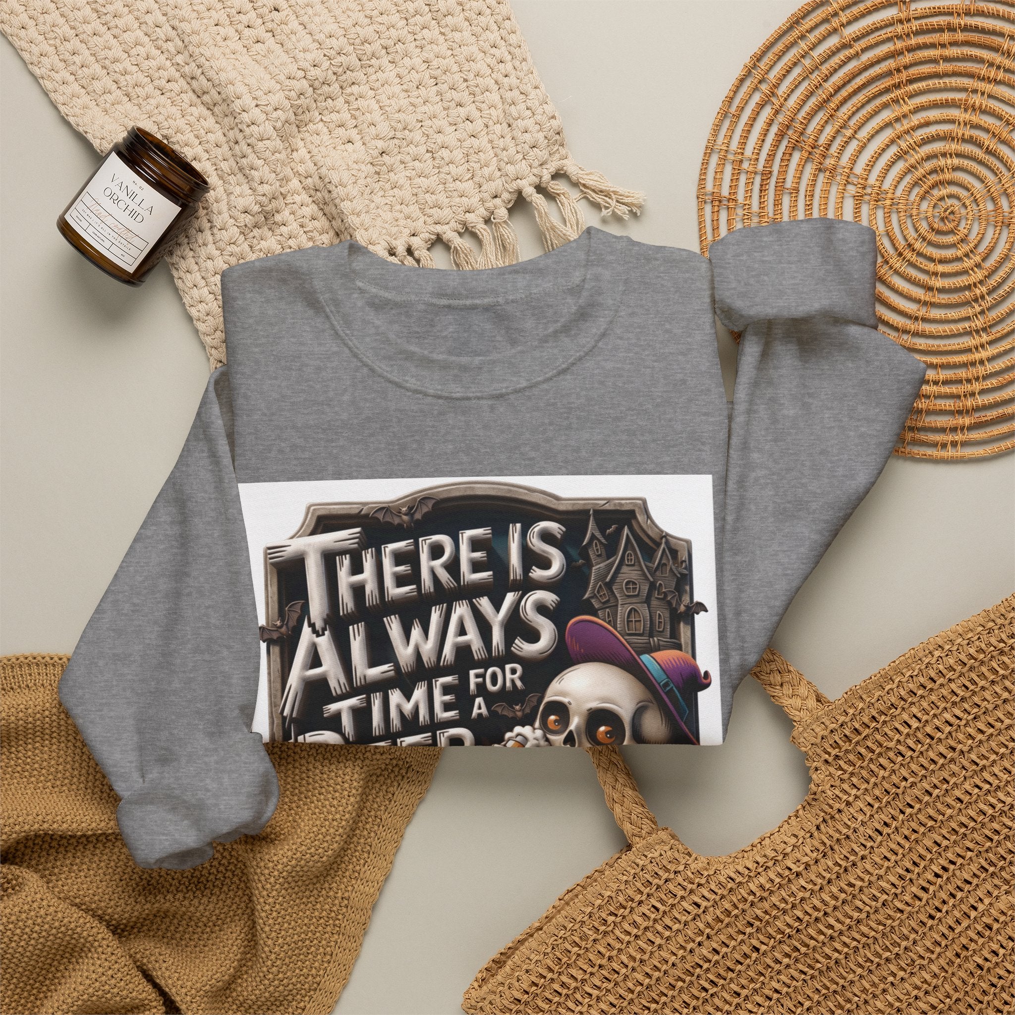 Graphite Heather crewneck sweatshirt styled flat with a candle — skeleton in a floppy purple hat