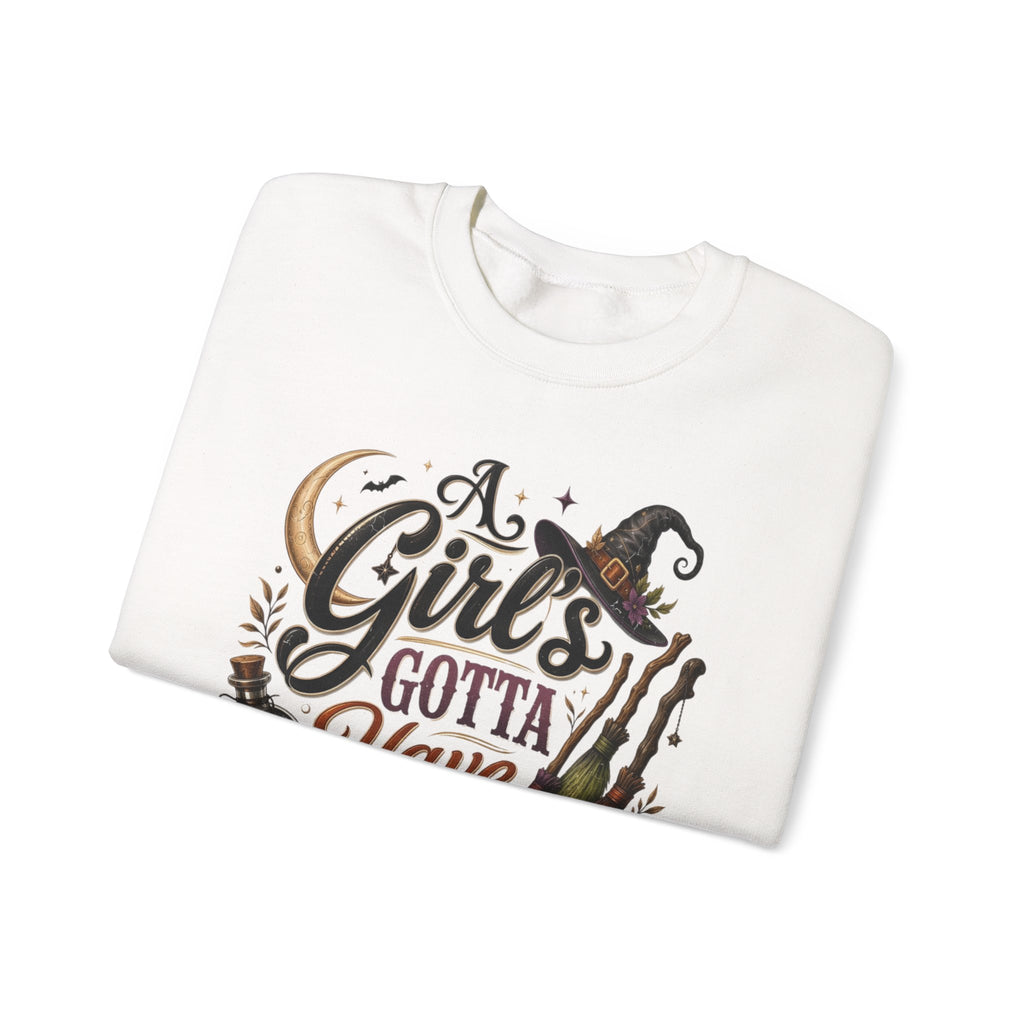 White crewneck sweatshirt folded to show the hand-lettered script reading a girl's gotta have options print