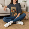 Dark Heather Grey t-shirt laid flat, printed with a skeleton in a knitted sweater raising a paper cup