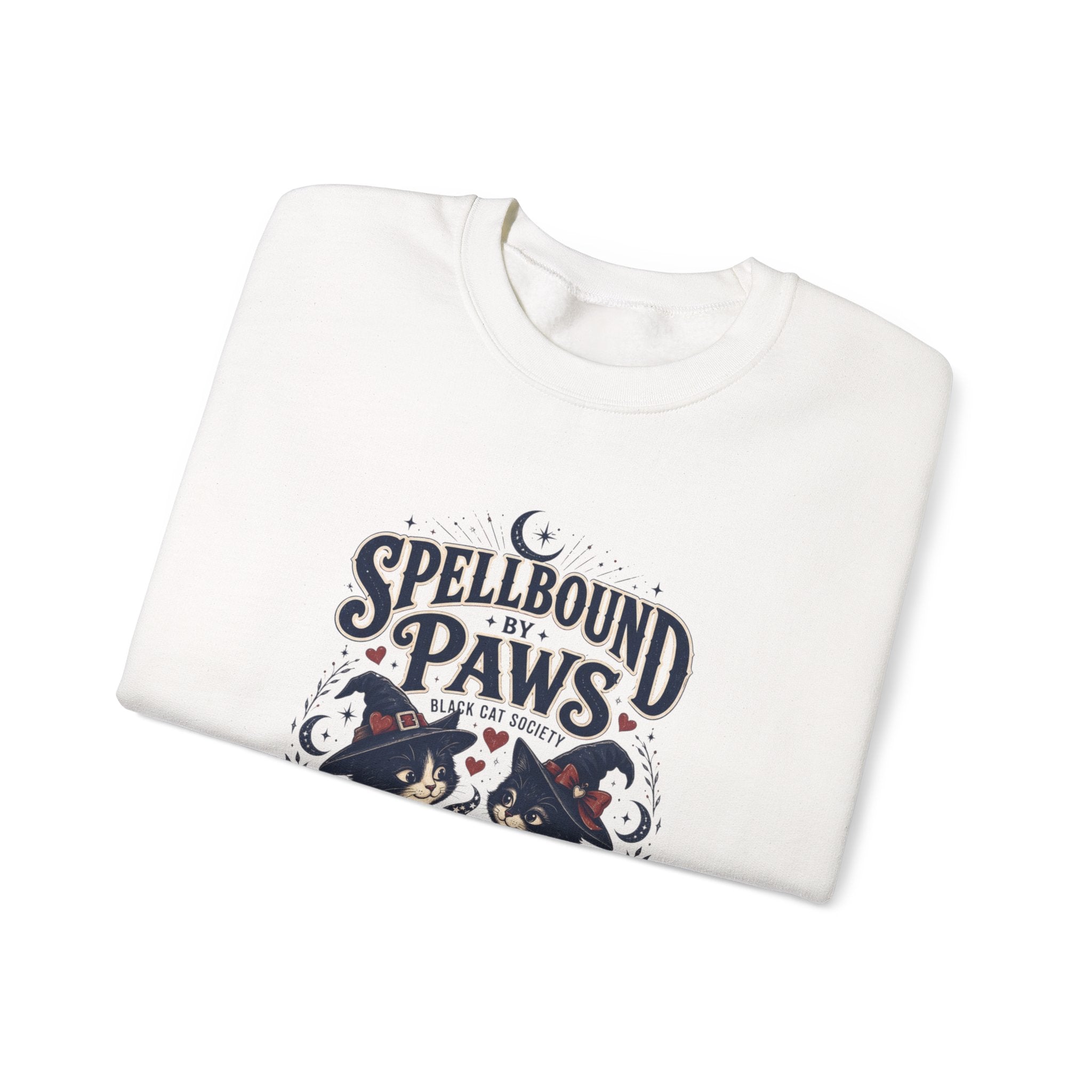 White crewneck sweatshirt folded to show the two black cats in witch hats print