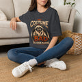 Dark Heather Grey t-shirt laid flat, printed with a wide-eyed raccoon holding open a shabby fur cape as