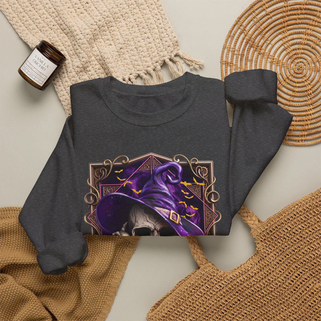 Dark Heather crewneck sweatshirt styled flat with a candle — skull in a purple witch hat