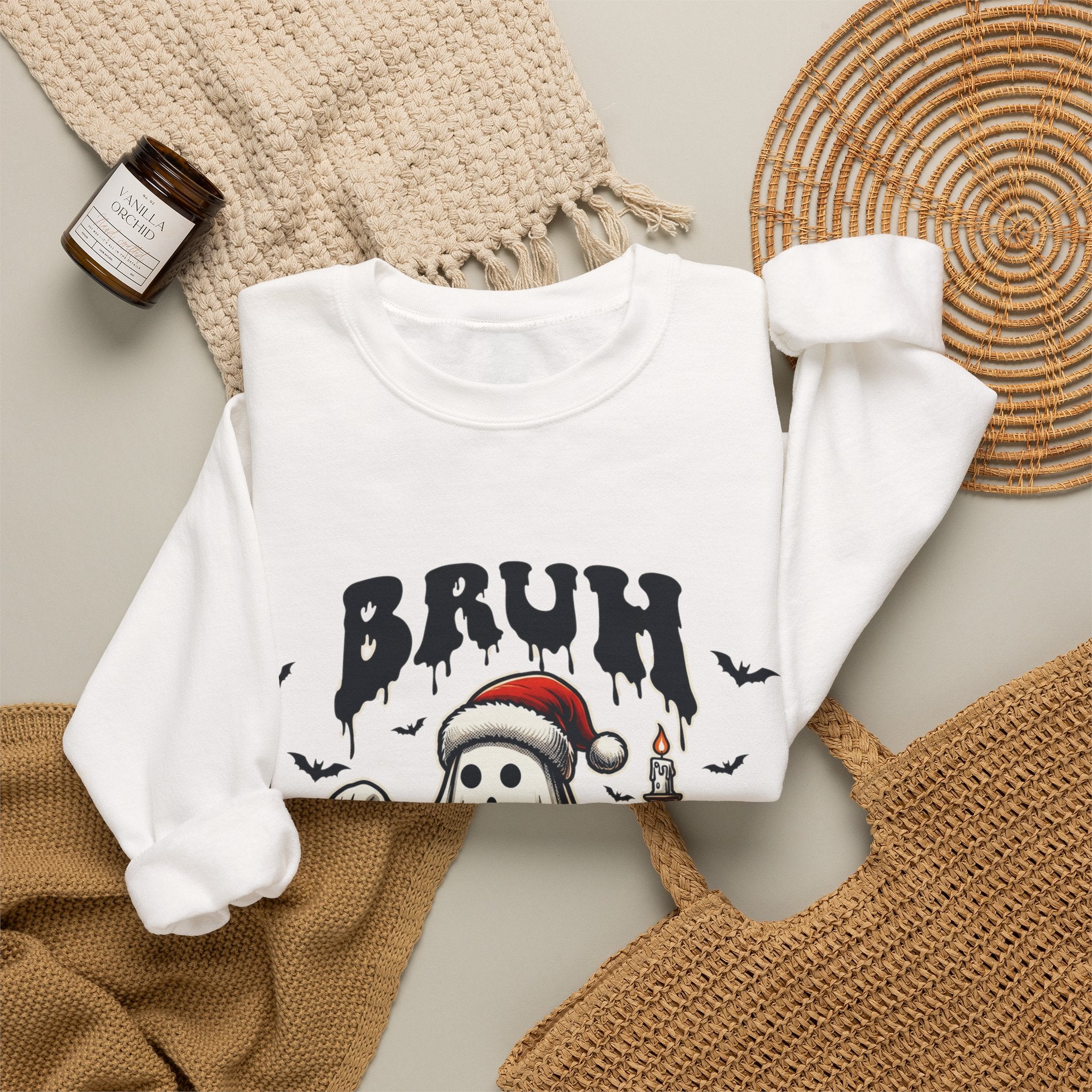 White crewneck sweatshirt styled flat with a candle — ghost in a Santa hat