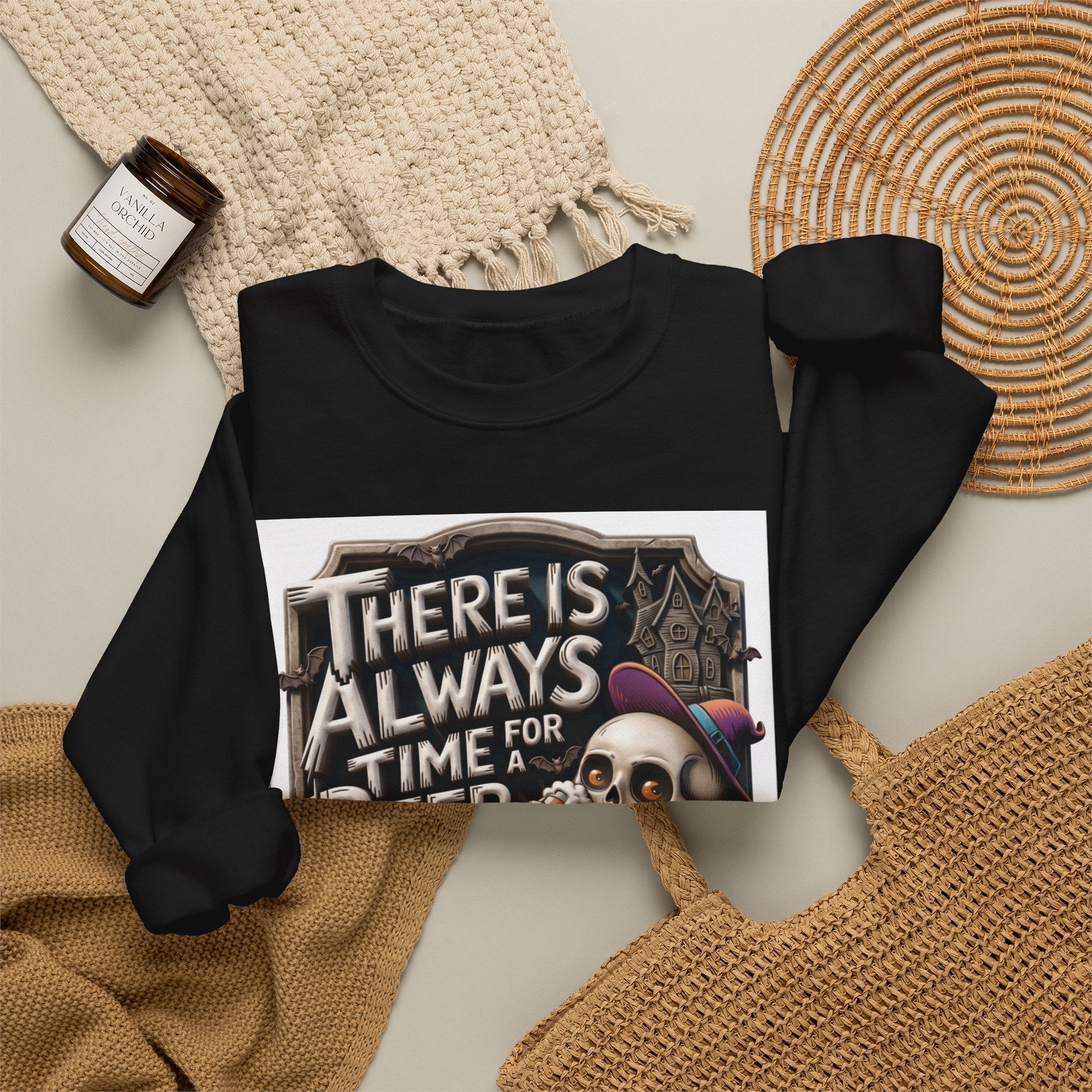 Black crewneck sweatshirt styled flat with a candle — skeleton in a floppy purple hat