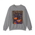 Graphite Heather crewneck sweatshirt laid flat, printed with a grinning witch in a pointed hat looms over glowing