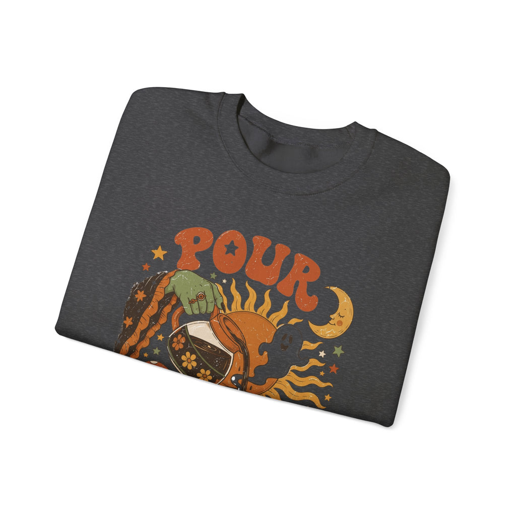 Dark Heather crewneck sweatshirt folded to show the green witch hand tipping a flower-patterned coffee pot into print
