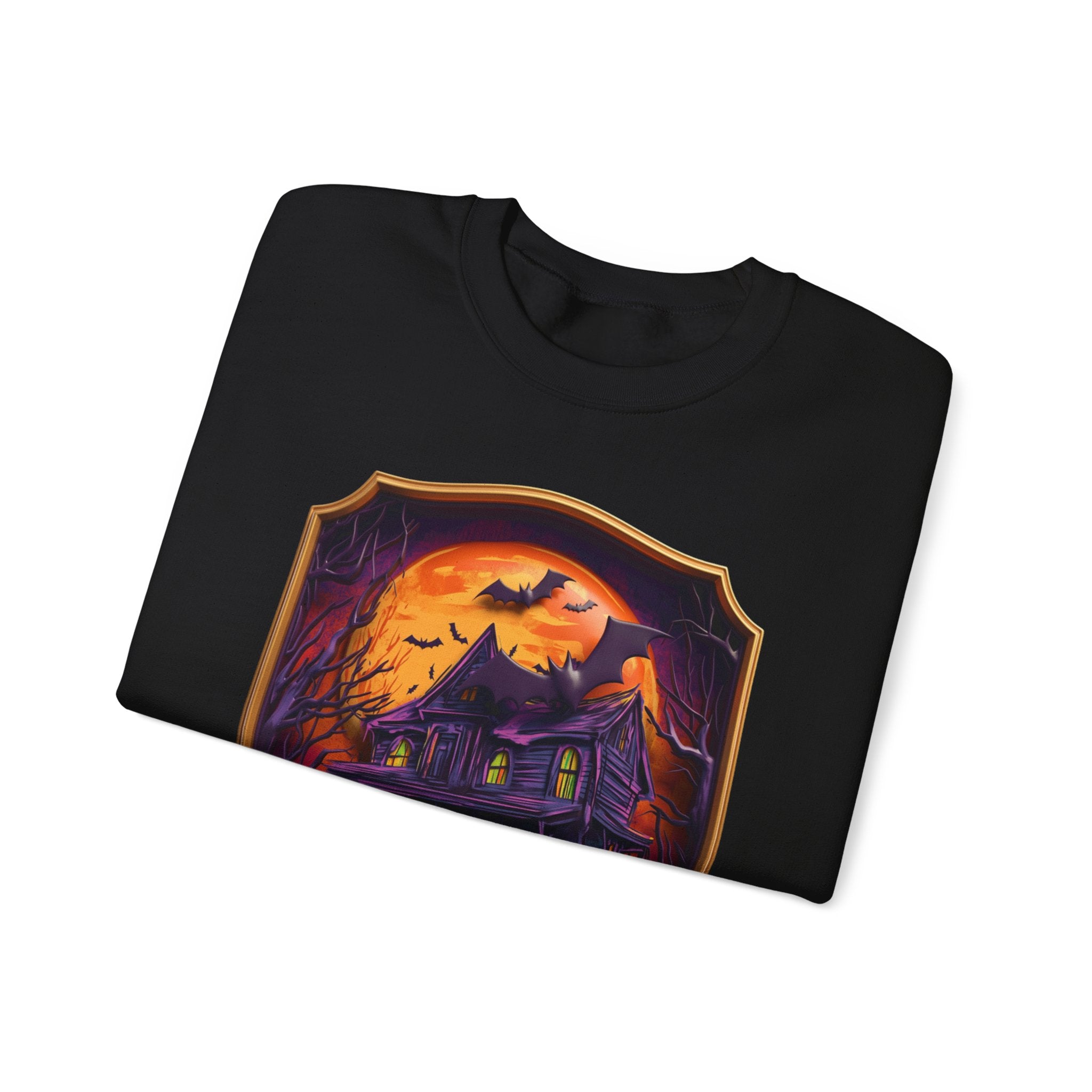 Black crewneck sweatshirt folded to show the purple haunted mansion sits under a blazing orange moon print