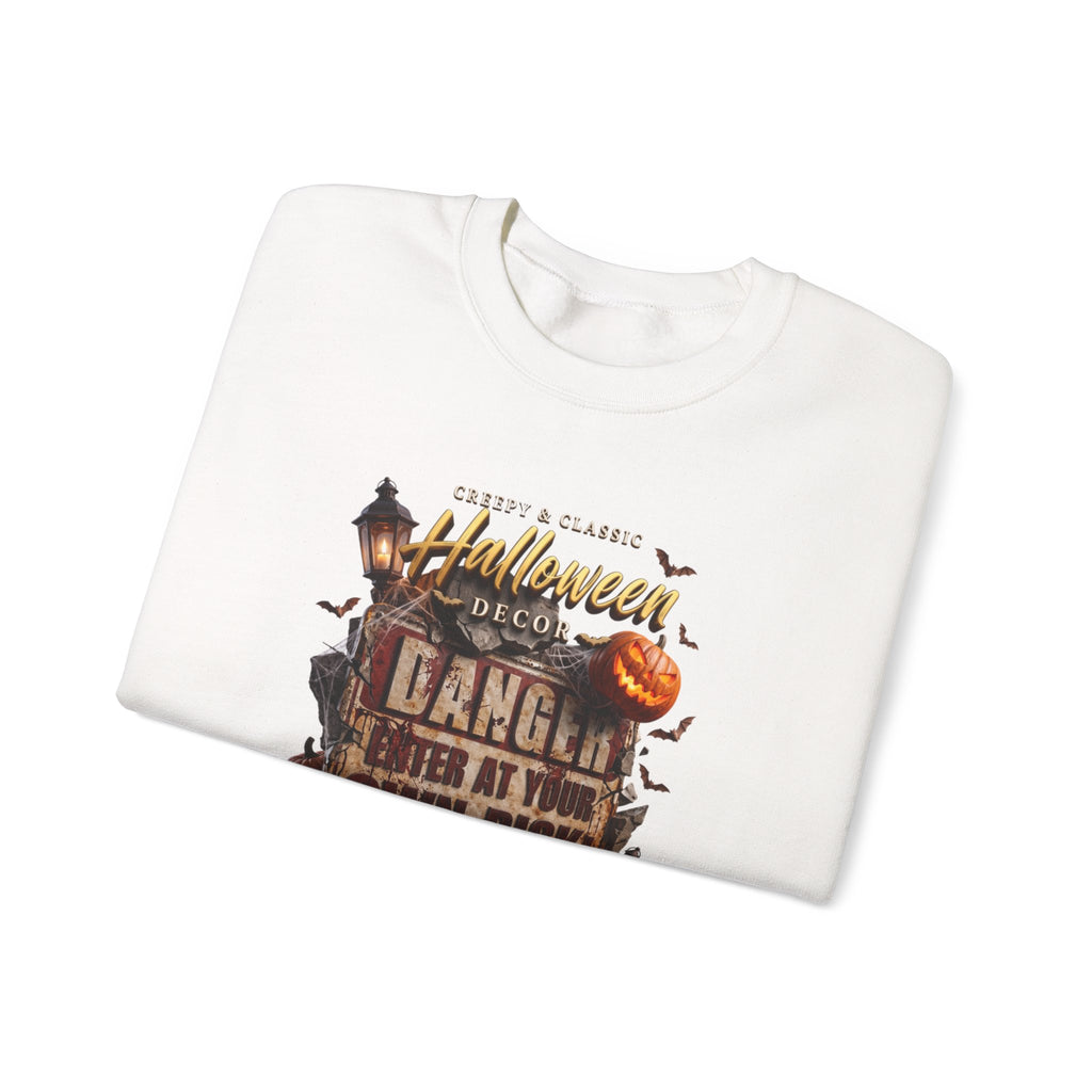 White crewneck sweatshirt folded to show the aged danger sign hangs above a cluster of glowing print