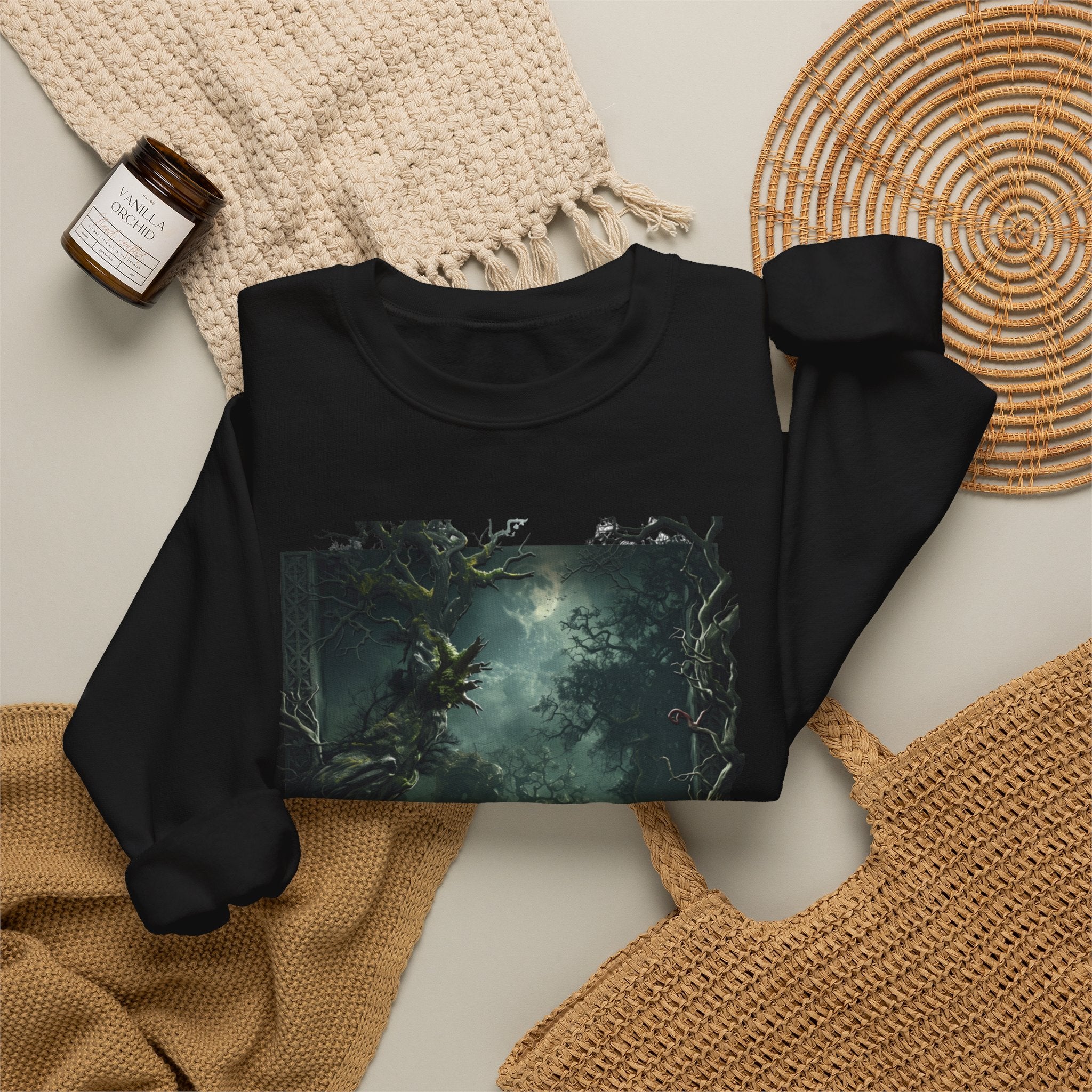 Black crewneck sweatshirt styled flat with a candle — moonlit forest of gnarled mossy trees