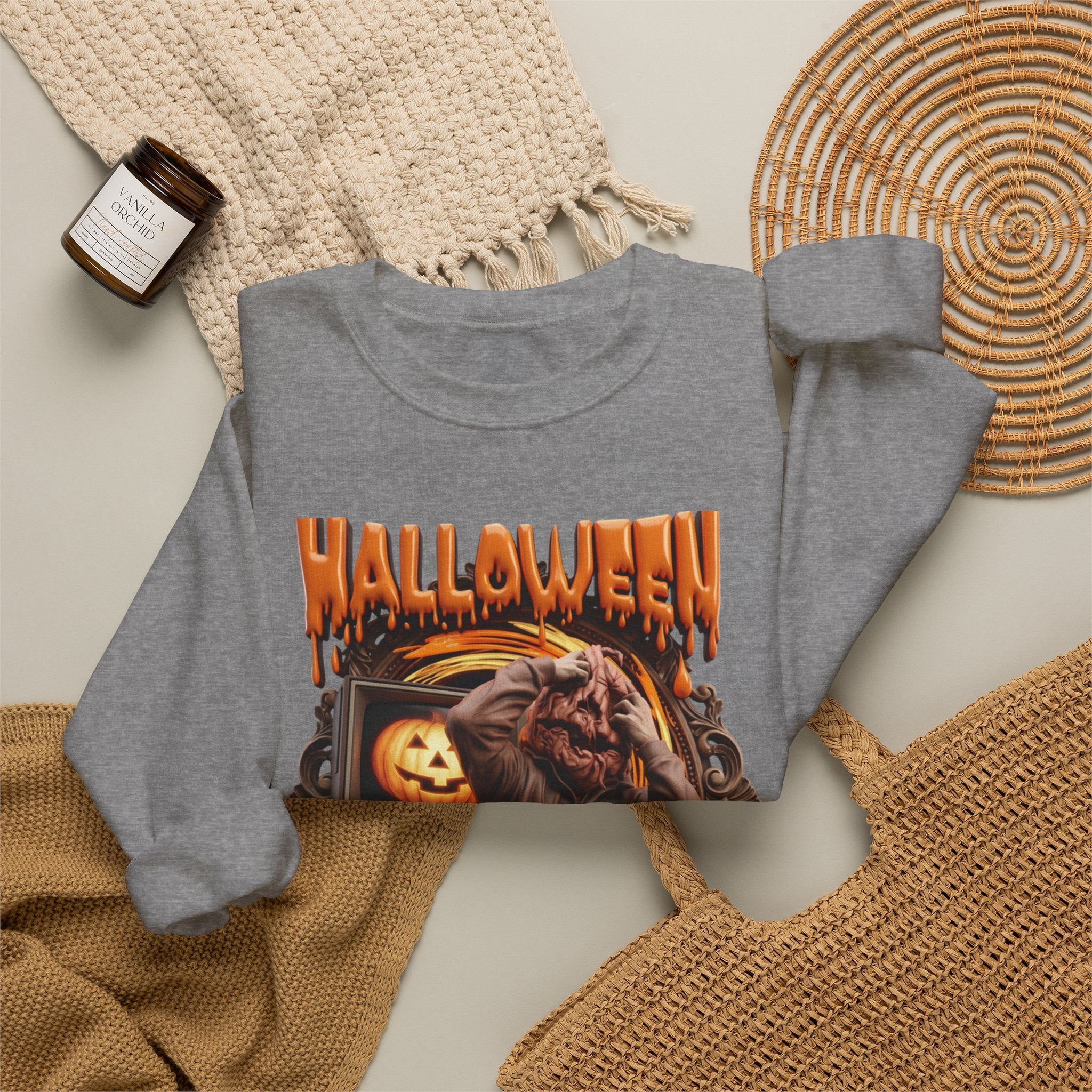 Graphite Heather crewneck sweatshirt styled flat with a candle — hunched monster clawing its own head