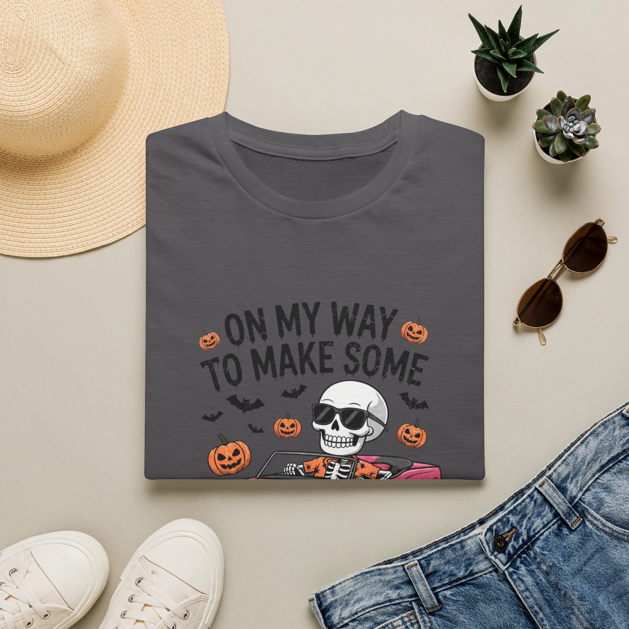 Charcoal t-shirt styled flat with a candle — pink convertible car and a skull