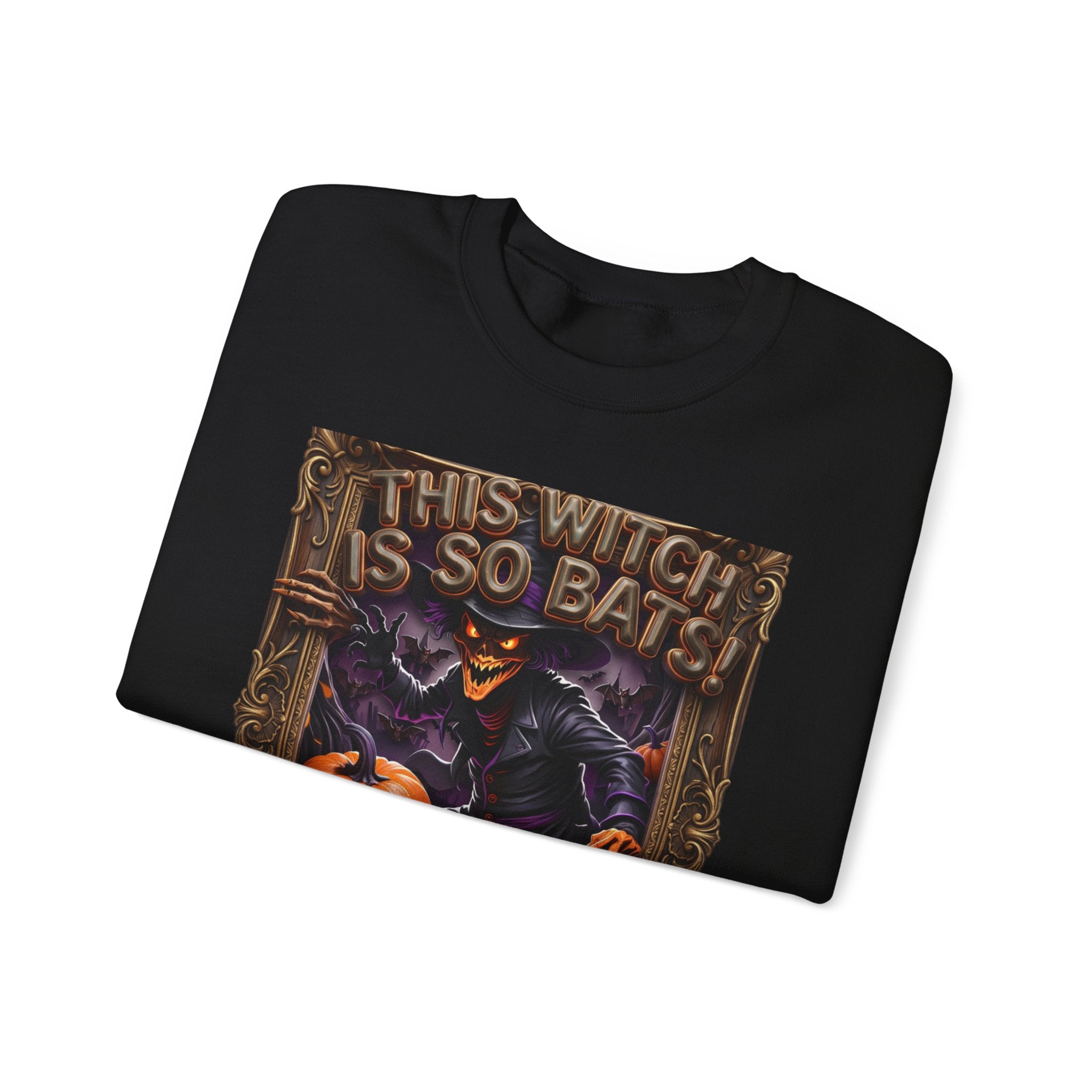 Black crewneck sweatshirt folded to show the grinning witch in a pointed hat looms over glowing print