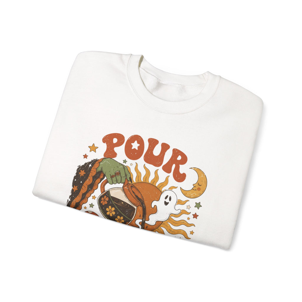 White crewneck sweatshirt folded to show the green witch hand tipping a flower-patterned coffee pot into print