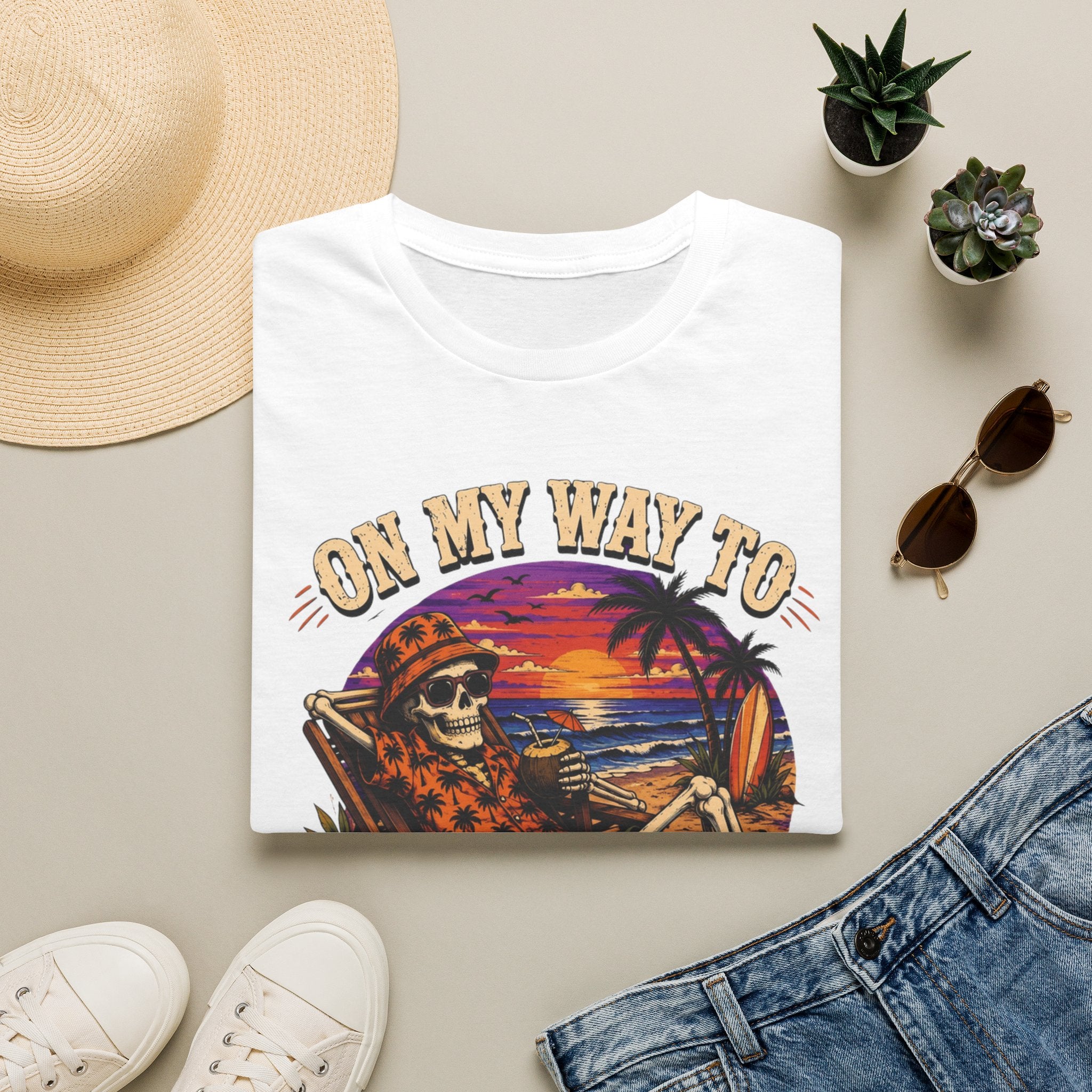 White t-shirt styled flat with a candle — skeleton on a beach at sunset