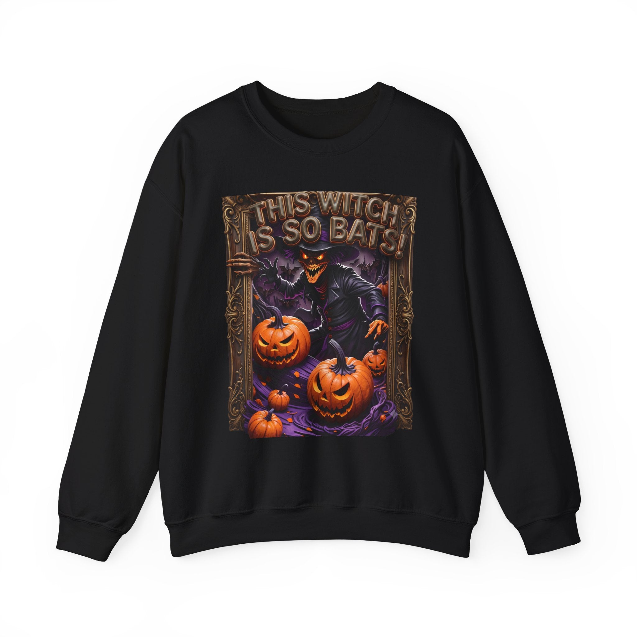 Black crewneck sweatshirt laid flat, printed with a grinning witch in a pointed hat looms over glowing