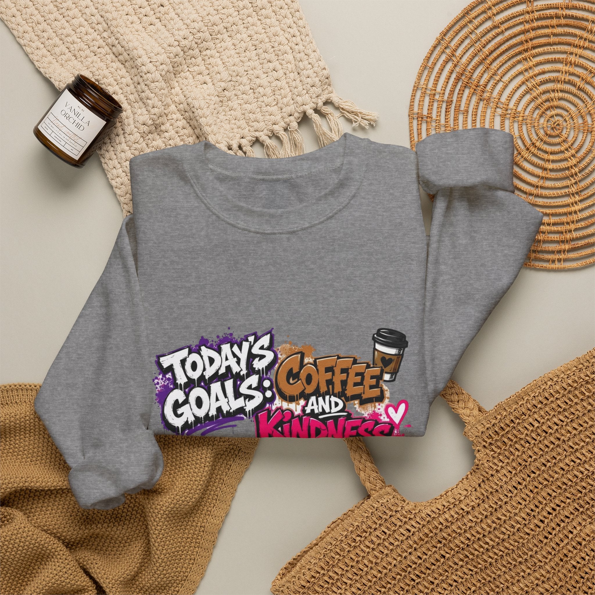 Graphite Heather crewneck sweatshirt styled flat with a candle — graffiti lettering in electric pinks