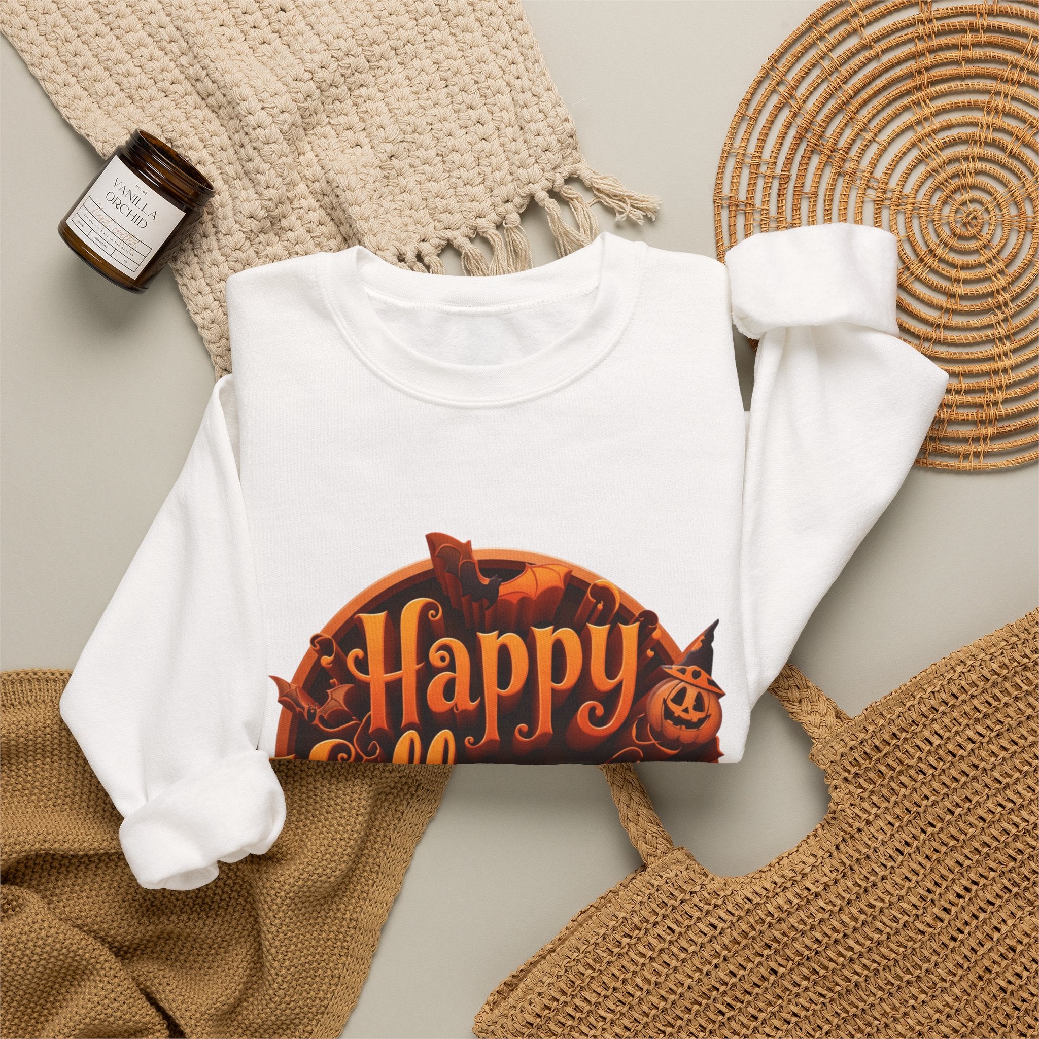 White crewneck sweatshirt styled flat with a candle — glowing orange Happy Halloween badge