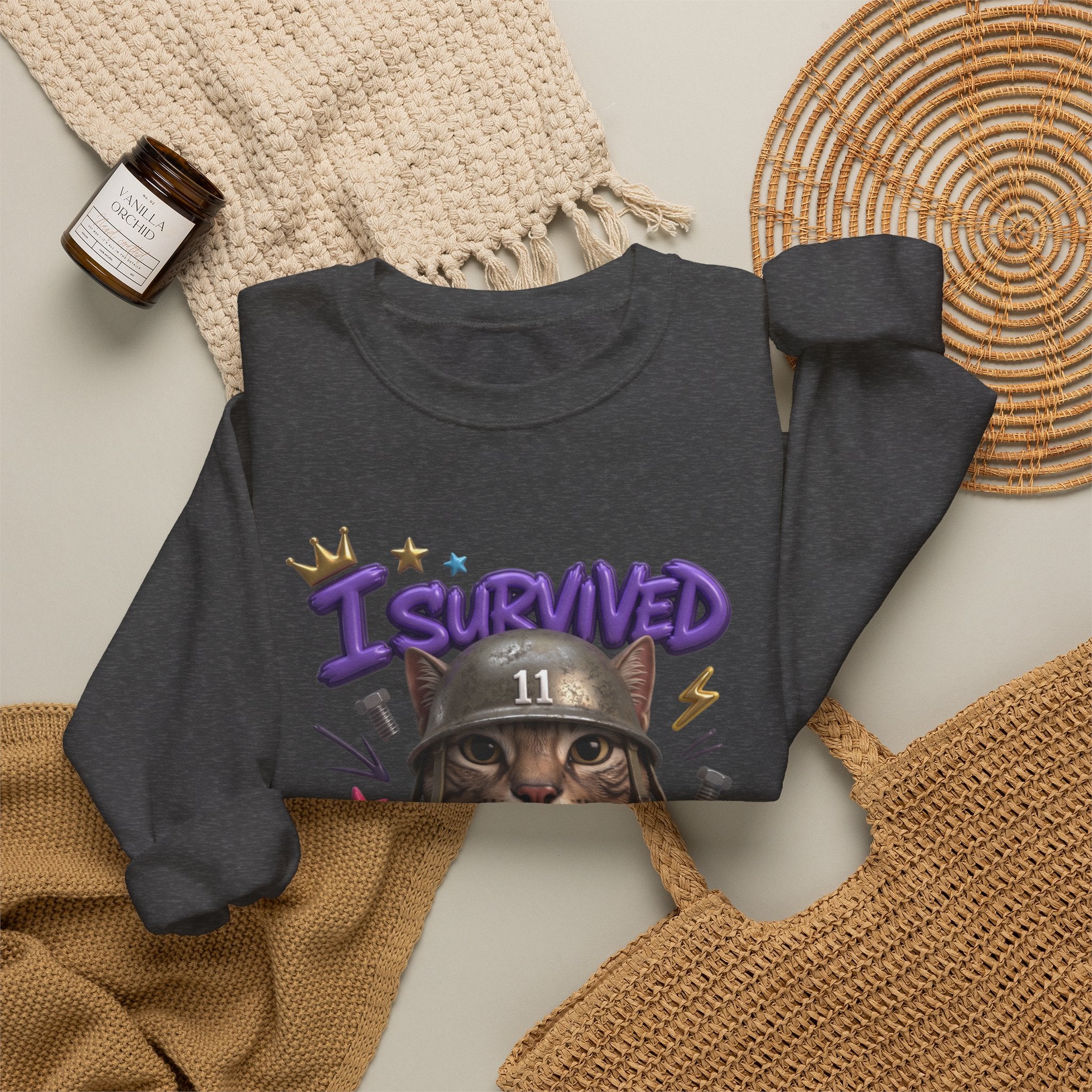 Dark Heather crewneck sweatshirt styled flat with a candle — flat-eyed cat in a steel helmet