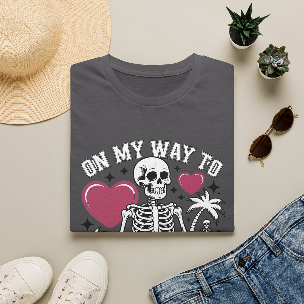 Charcoal t-shirt styled flat with a candle — line-drawn skeletons under pink hearts
