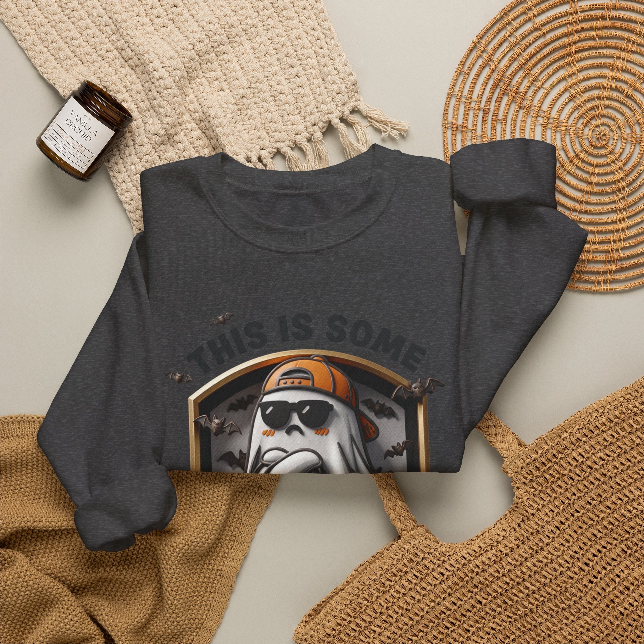Dark Heather crewneck sweatshirt styled flat with a candle — sheet ghost in an orange cap